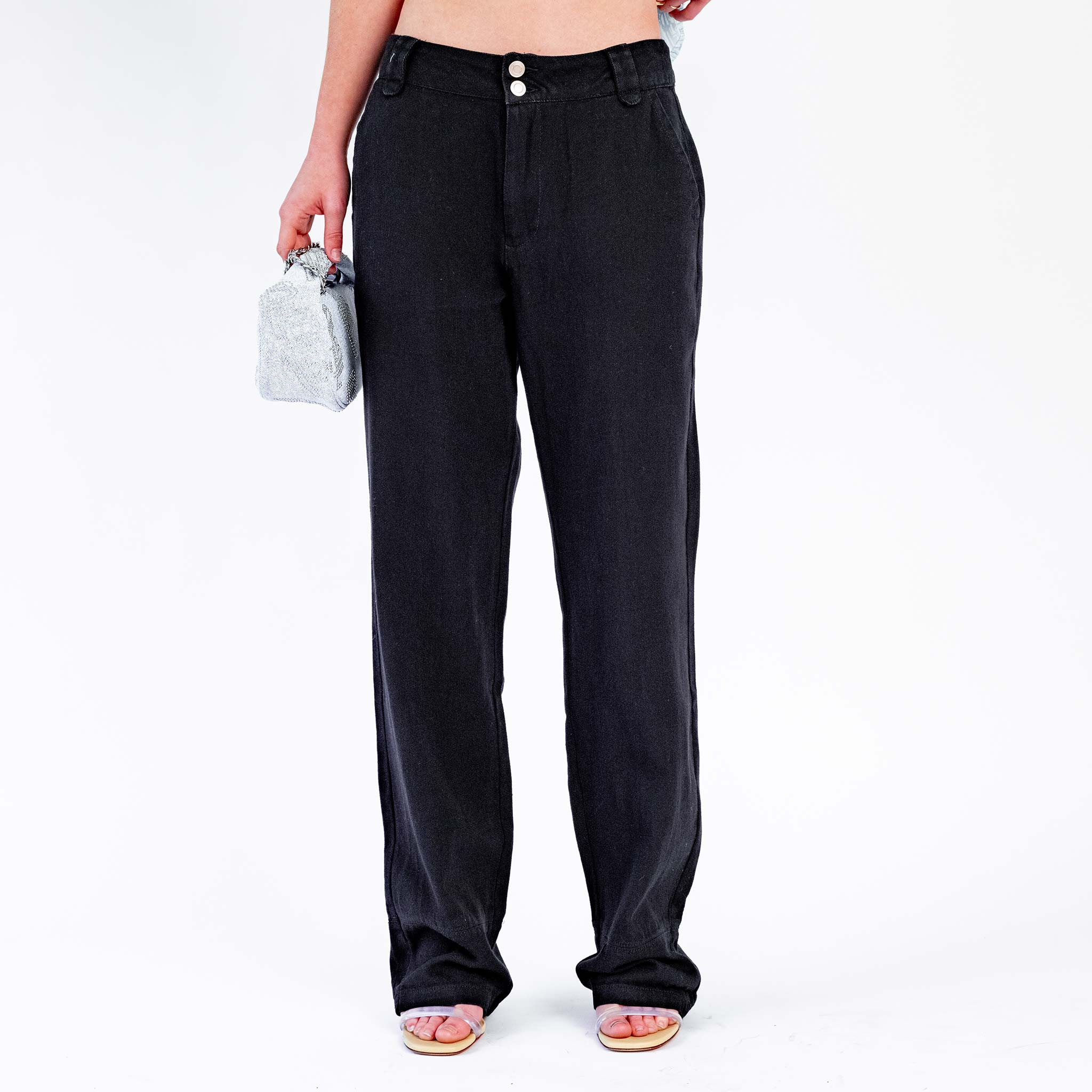 Close half body photo of model wearing the Low Rise Oversized Trousers - Black. 