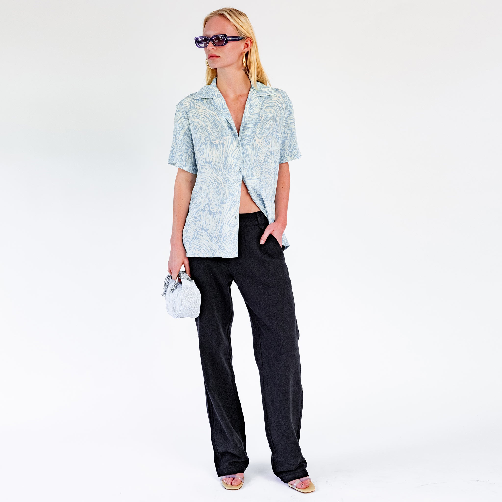 Full body photo of model wearing the Low Rise Oversized Trousers - Black. 