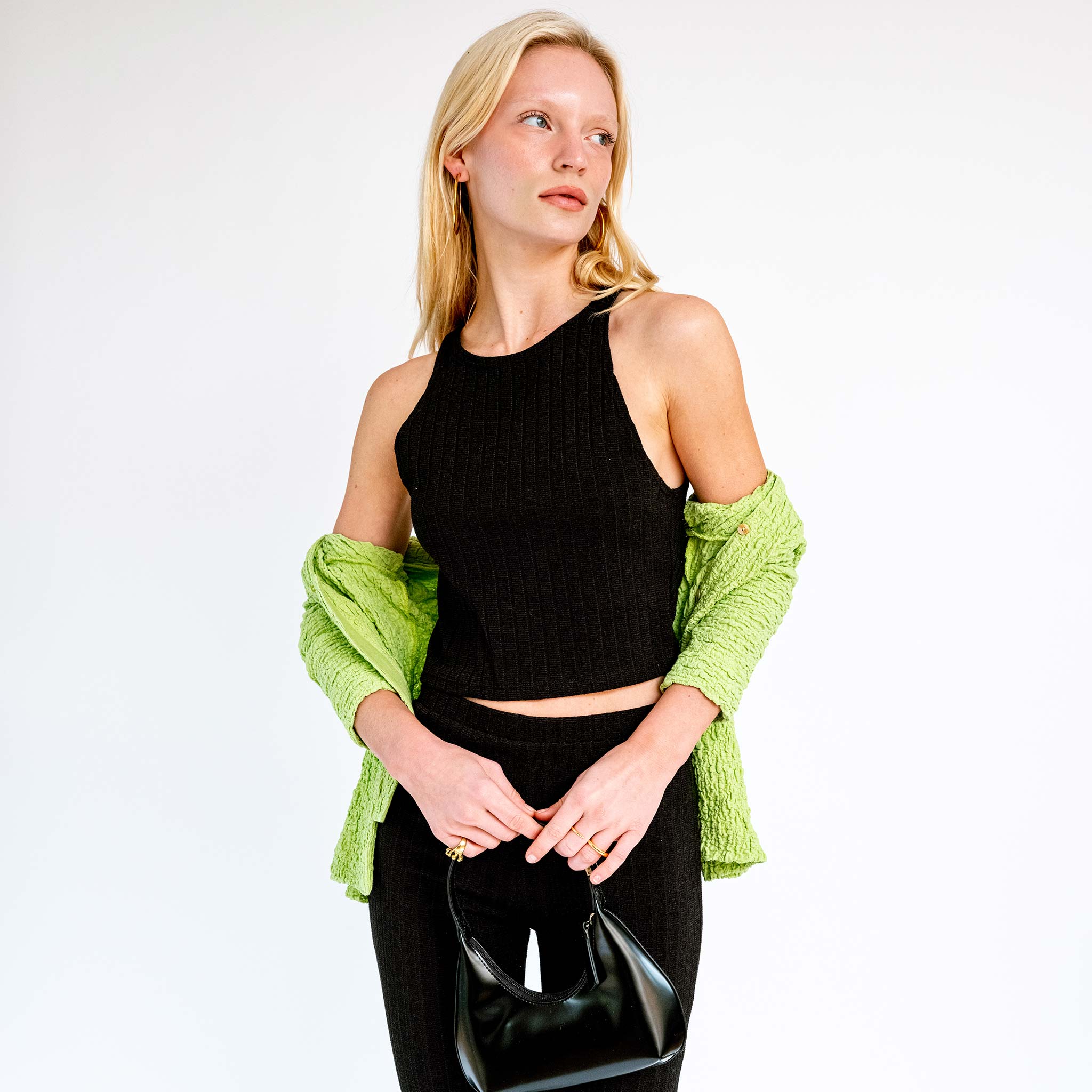 Close detail photo of model wearing the Low Side Cut Knit Tank - Black. 