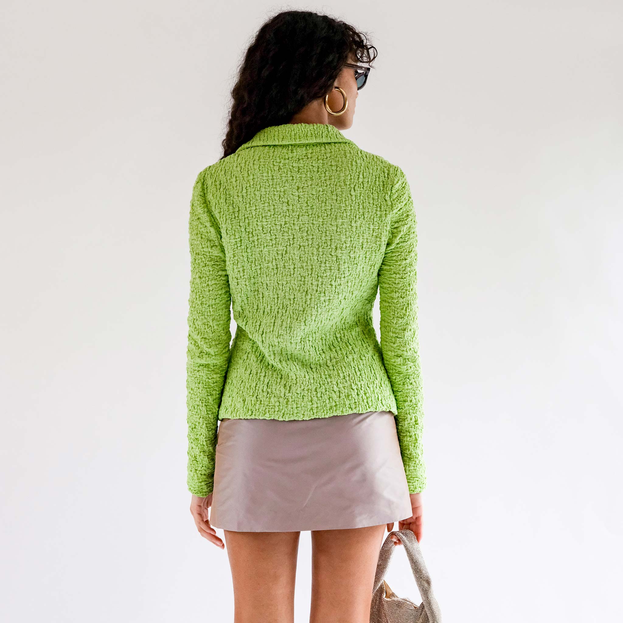 Back half body photo of model wearing the Lowry Top - Acid Green.
