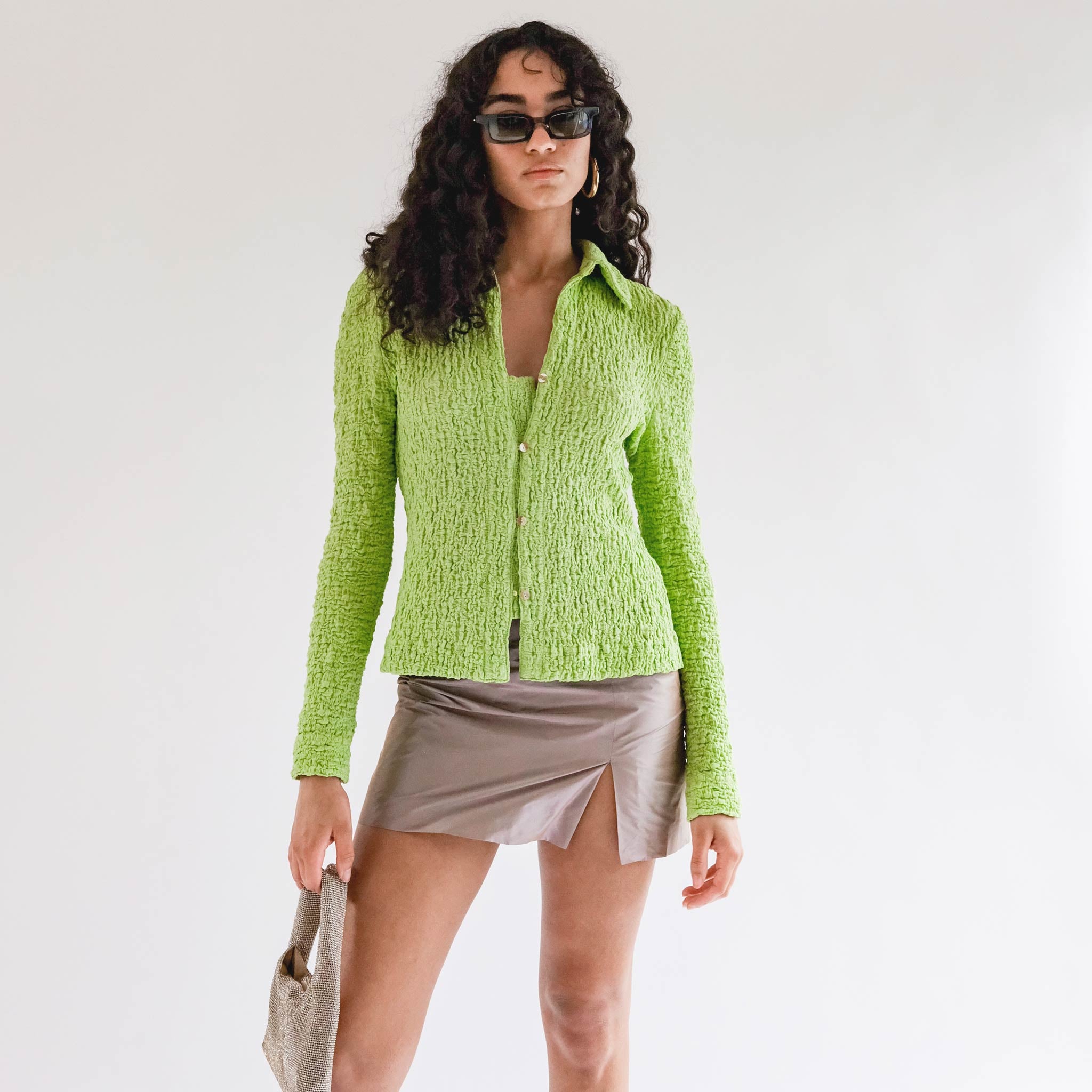 Close half body photo of model wearing the Lowry Top - Acid Green.