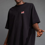 Close side detail photo of the Oversized Tee - Black 70s Multi.
