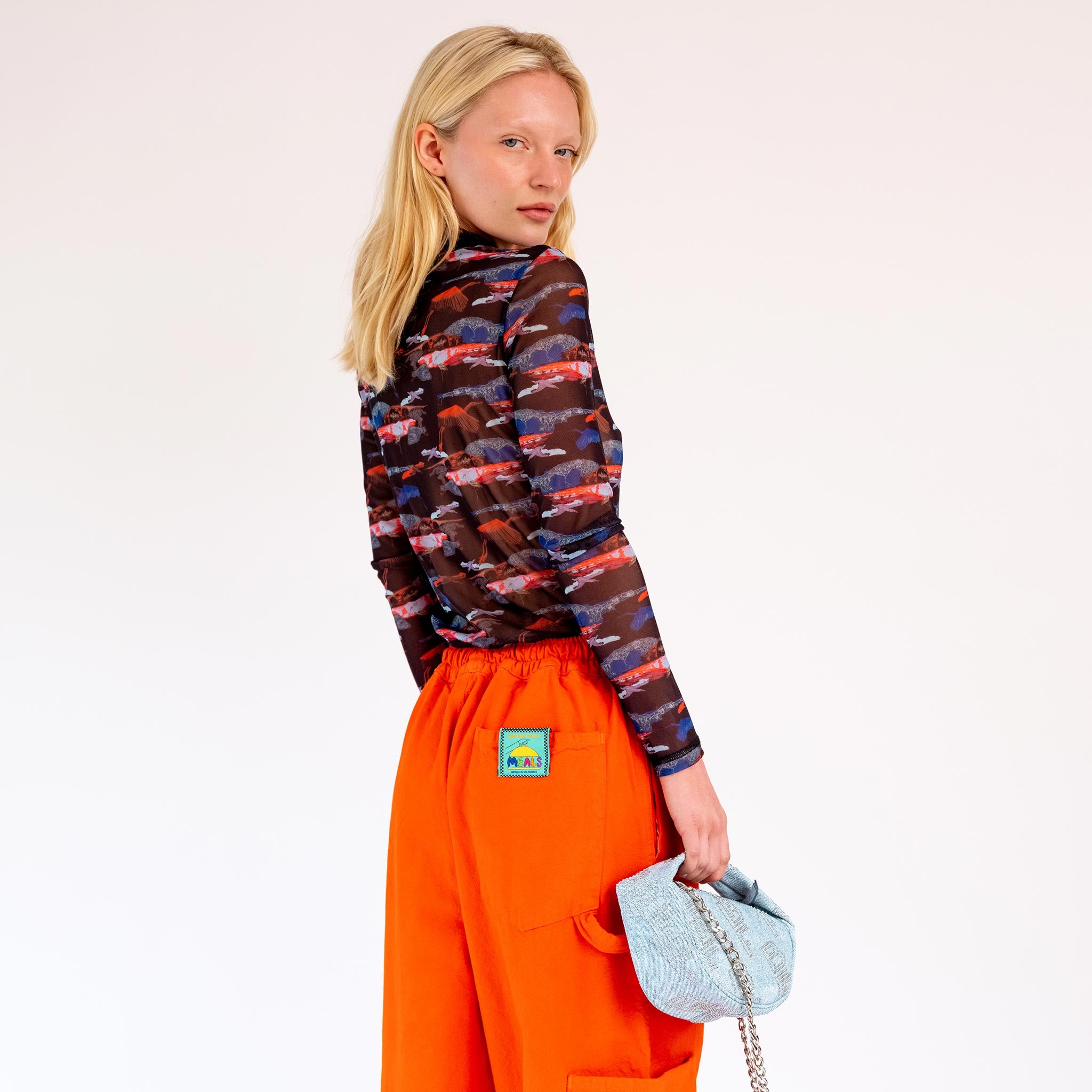 Back detail photo of model wearing the Mesh Turtleneck - Black Blue Birdie. 