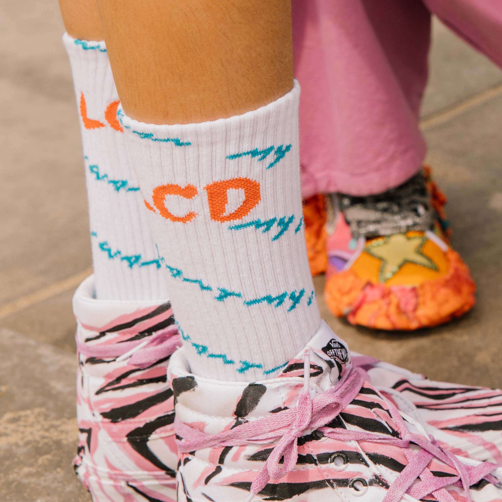 Close editorial detail photo of the LCD10 Motto Crew Socks. 