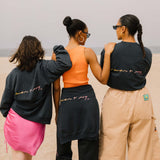 Editorial photo of 3 models wearing the Vintage Washed LCD10 Motto Crewneck. 