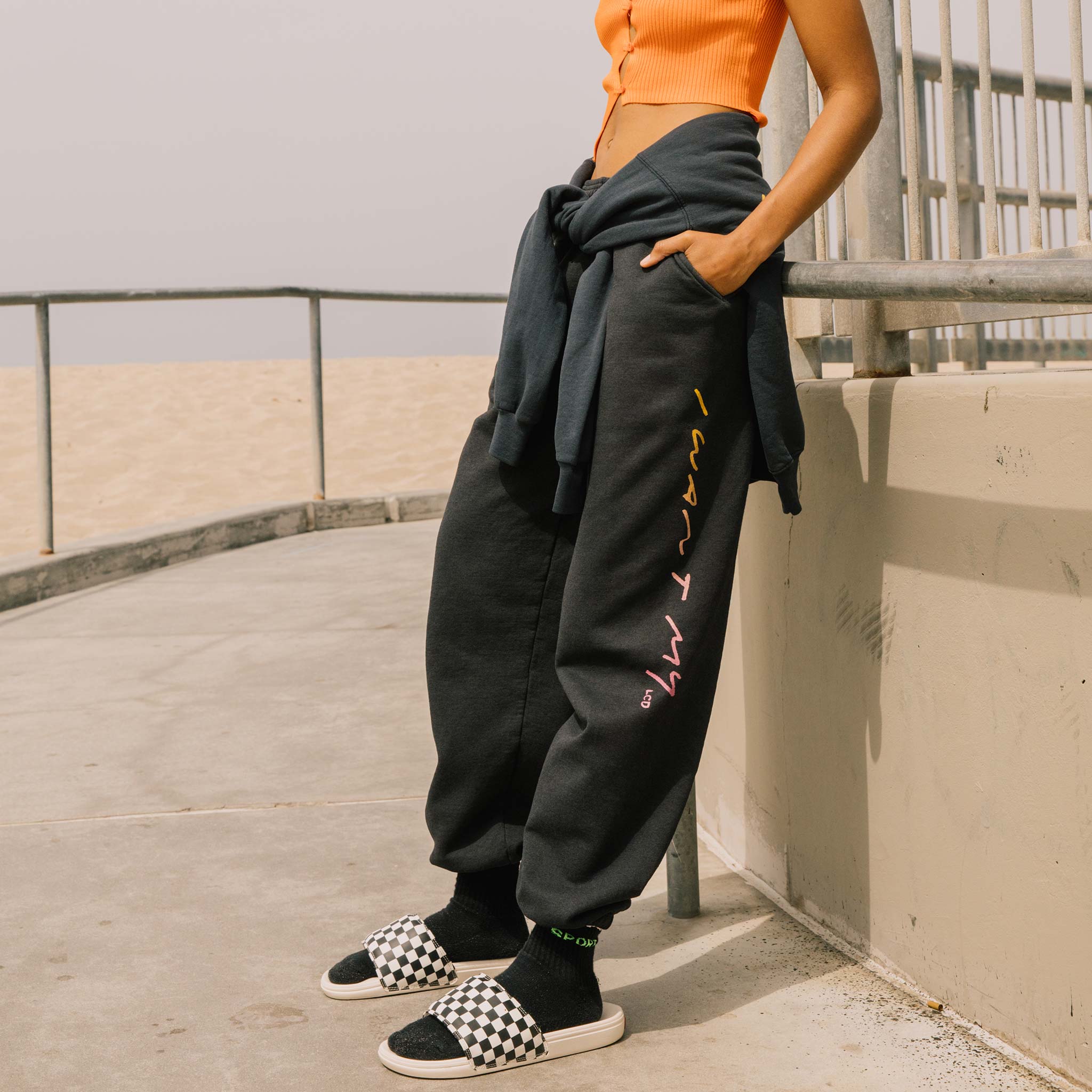 Close editorial photo of model wearing the Vintage Washed LCD10 Motto Sweatpants. 