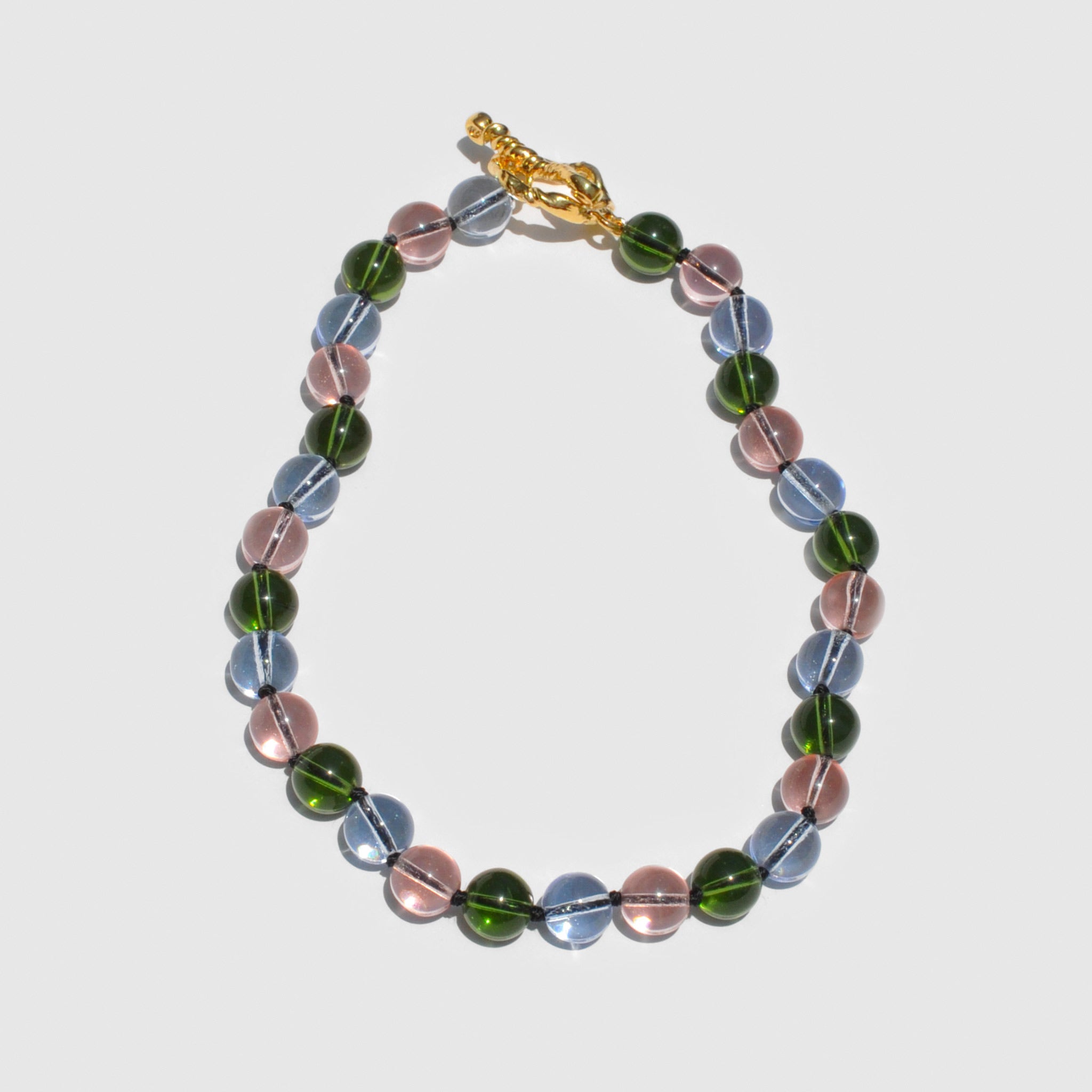 Nan Necklace - Multi Glass from Mondo Mondo, pink, blue, and green beaded necklace with gold clasp..