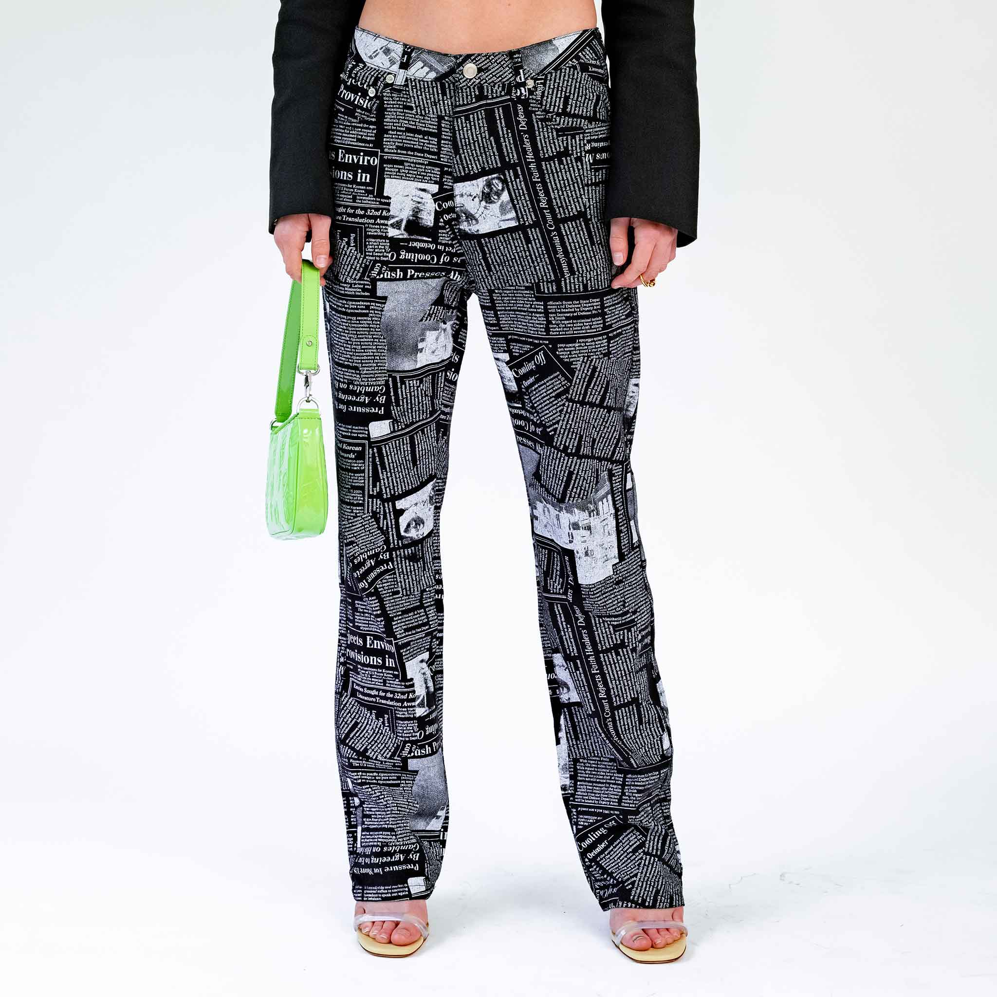 Close half body photo of model wearing the Newspaper Print Pocket Jeans - Black.
