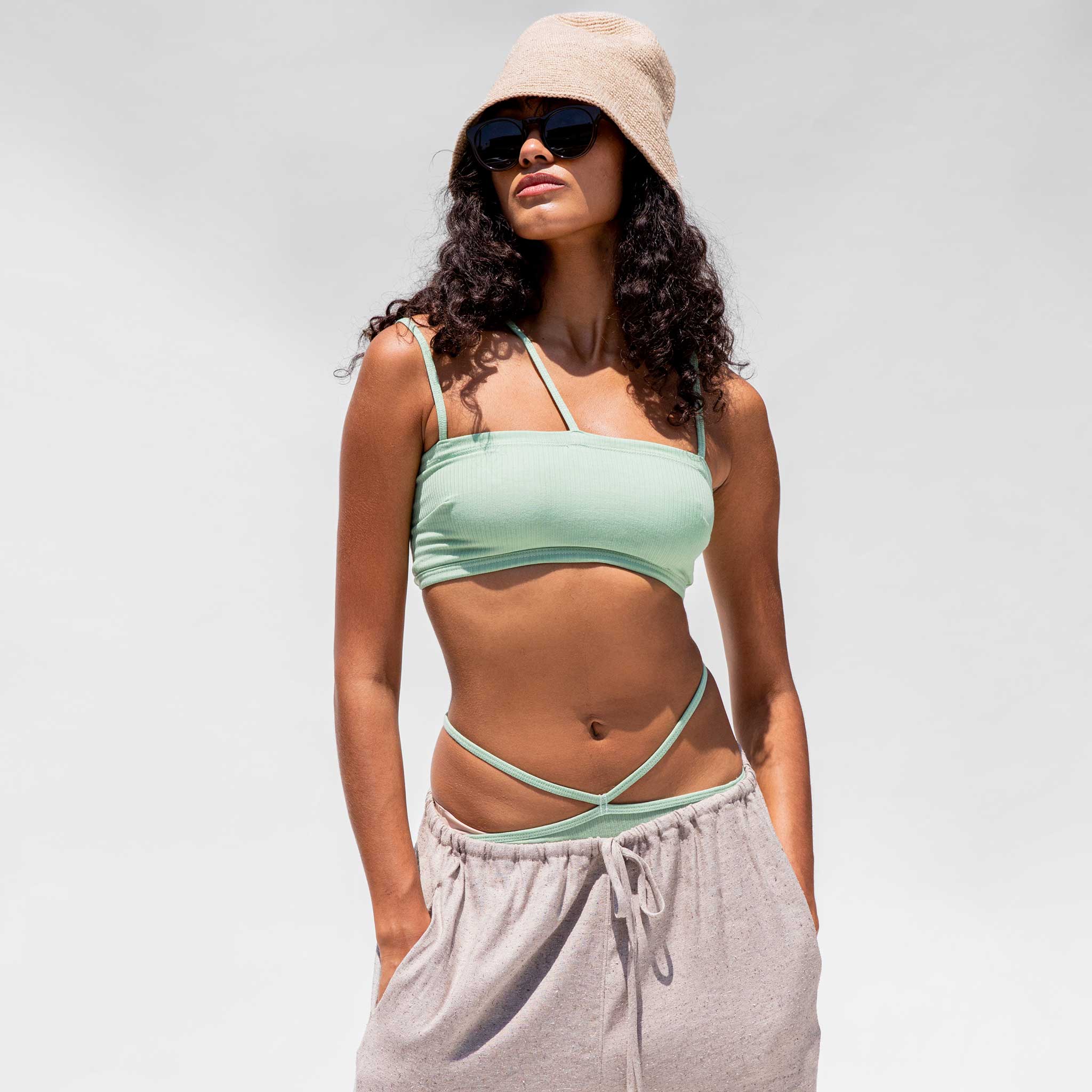 Close half body photo of model wearing the Nida Bra - Bar Green.