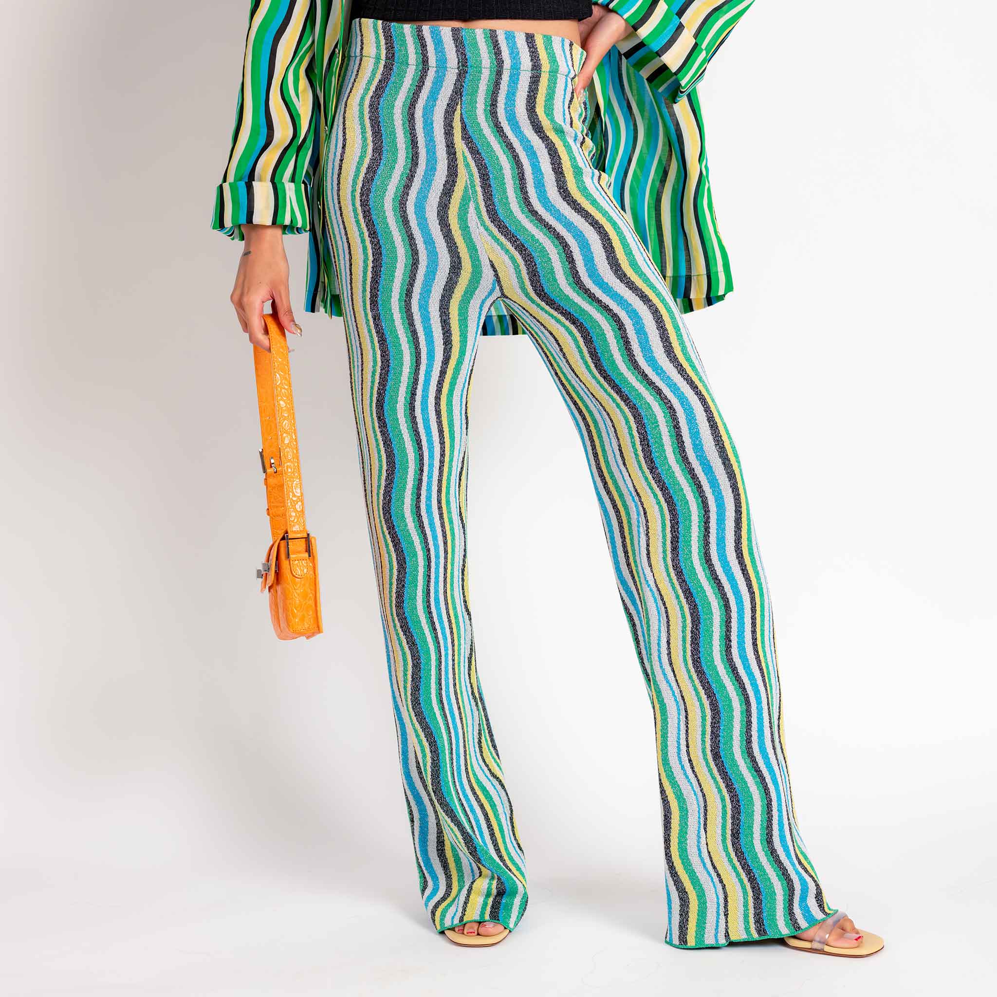 Close half body photo of model wearing the Nova Pant - Blue.