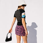 Back detail photo of model wearing the Oriental Towels Mini Skirt - Fuchsia.