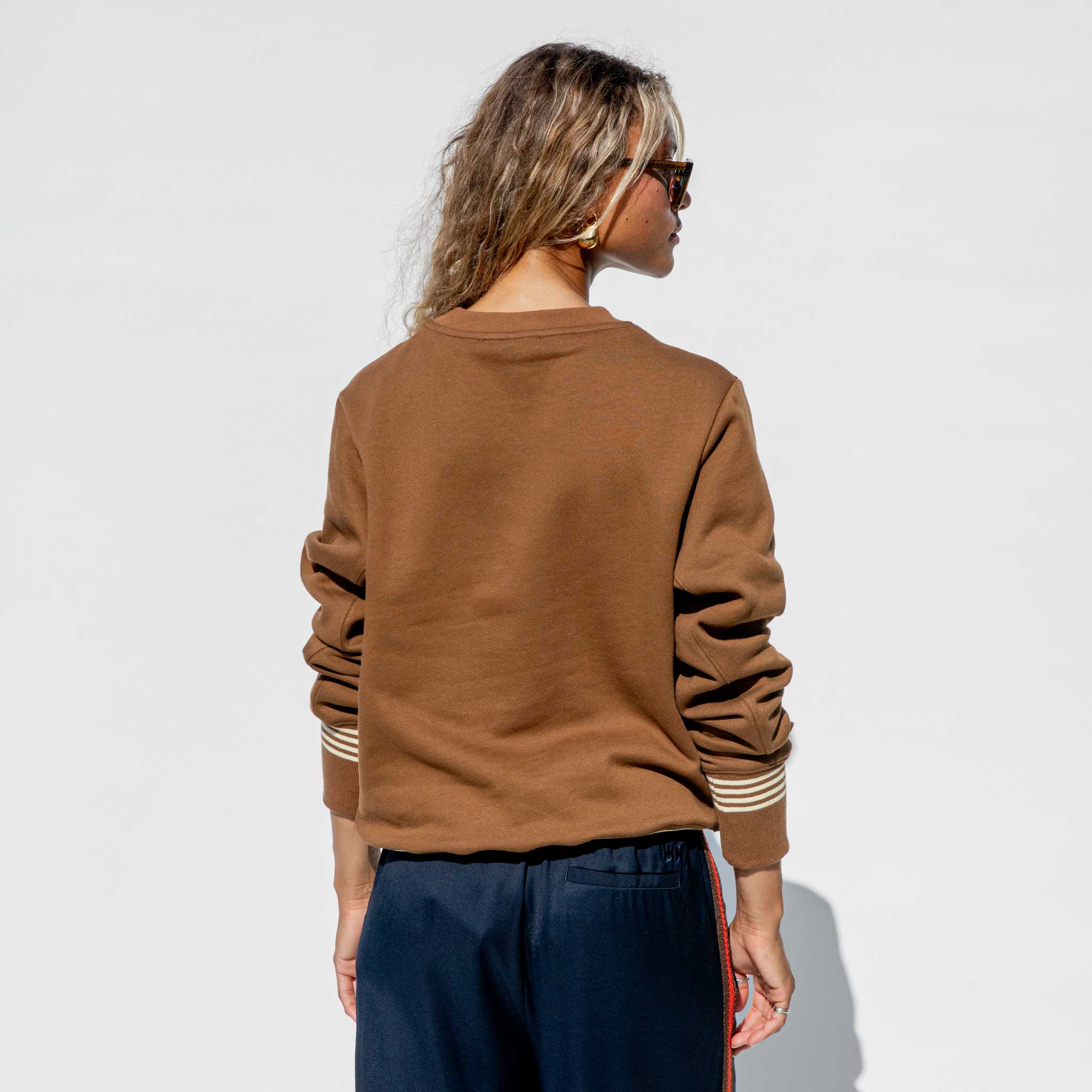 Back half body photo of model wearing the Original Sweatshirt - Brown.