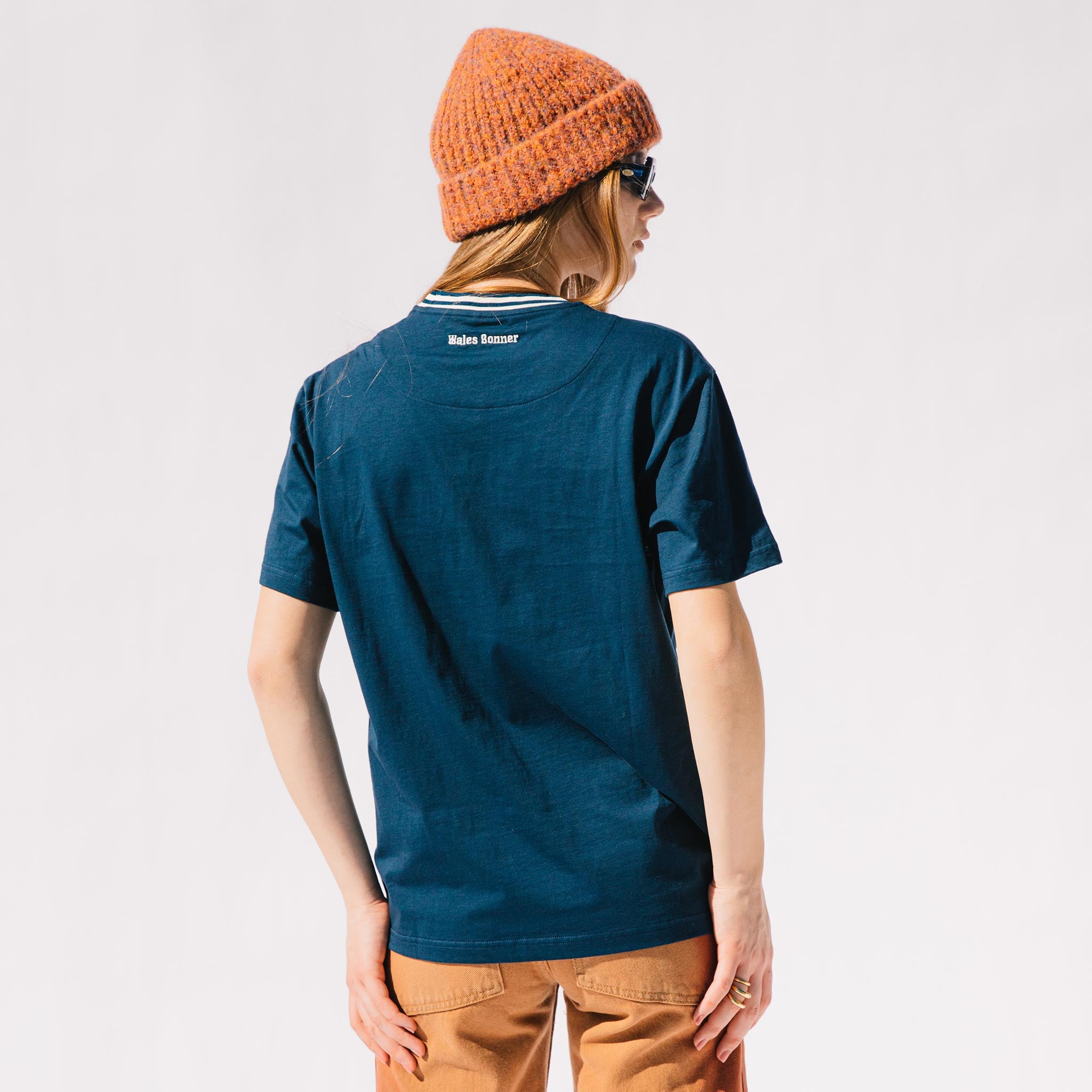 Back half body photo of model wearing the Original Tee - Navy.
