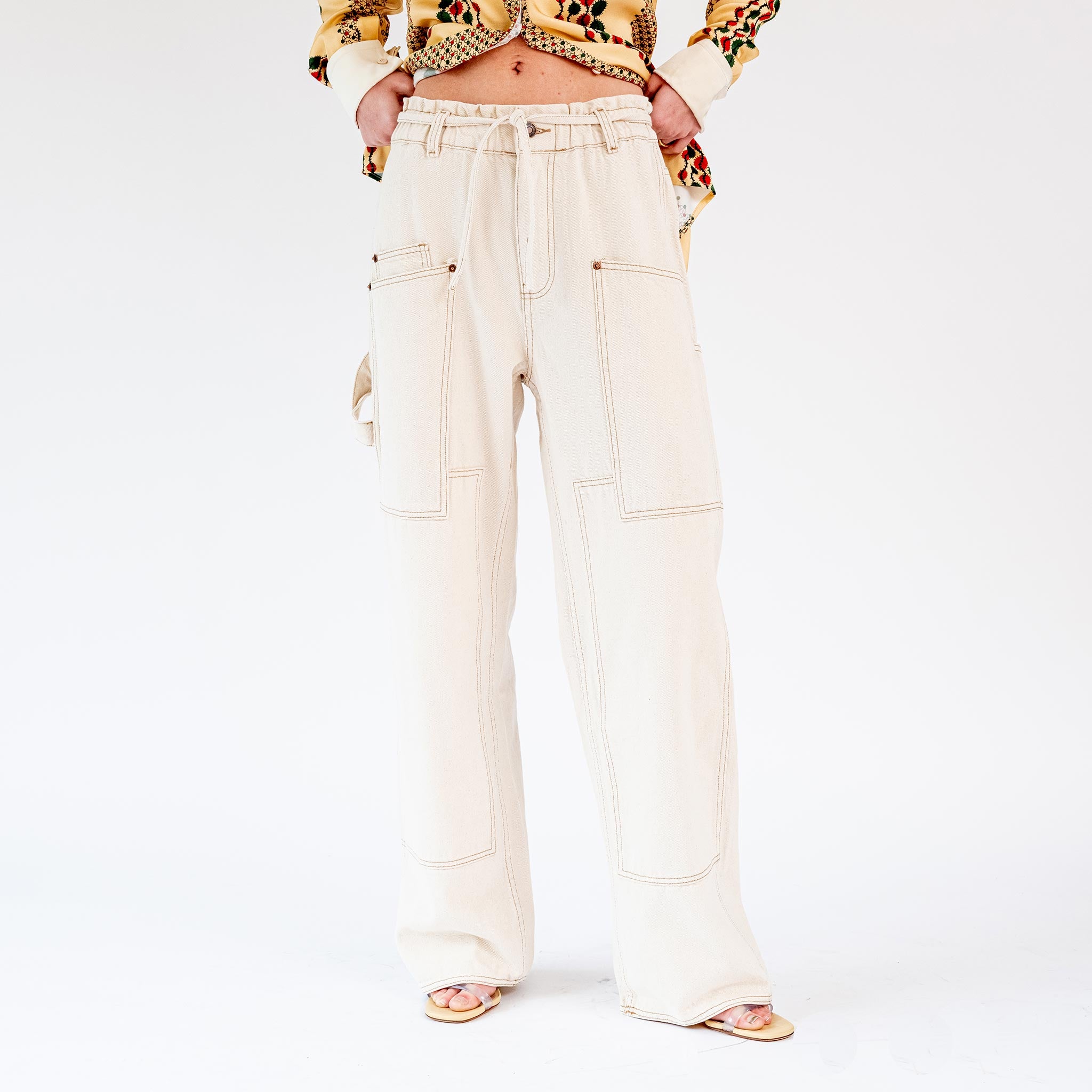 Front half body photo of model wearing the Paperbag Carpenter Pant - Natural.