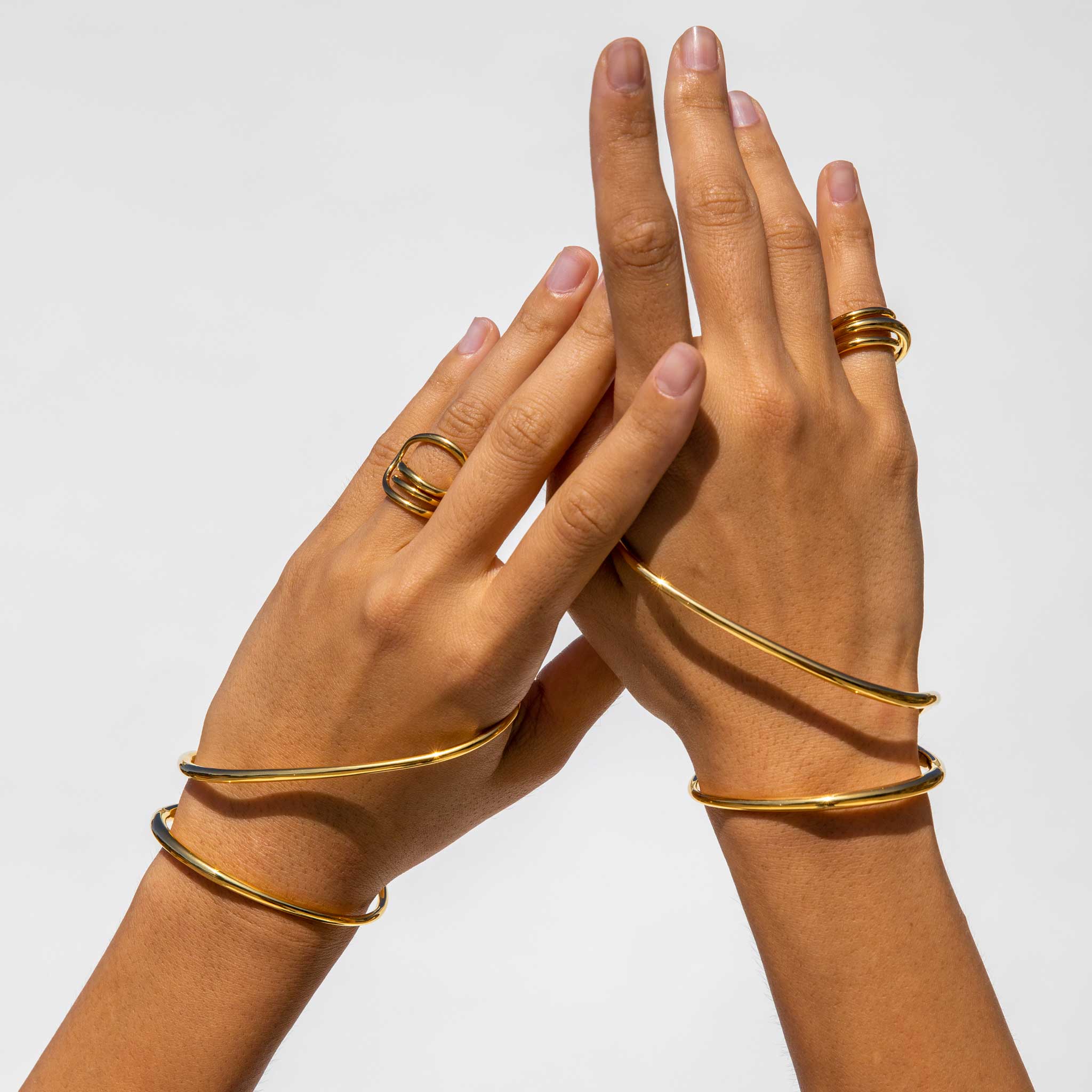 Close detail photo of two hand wearing the Petit Round Trip Ring