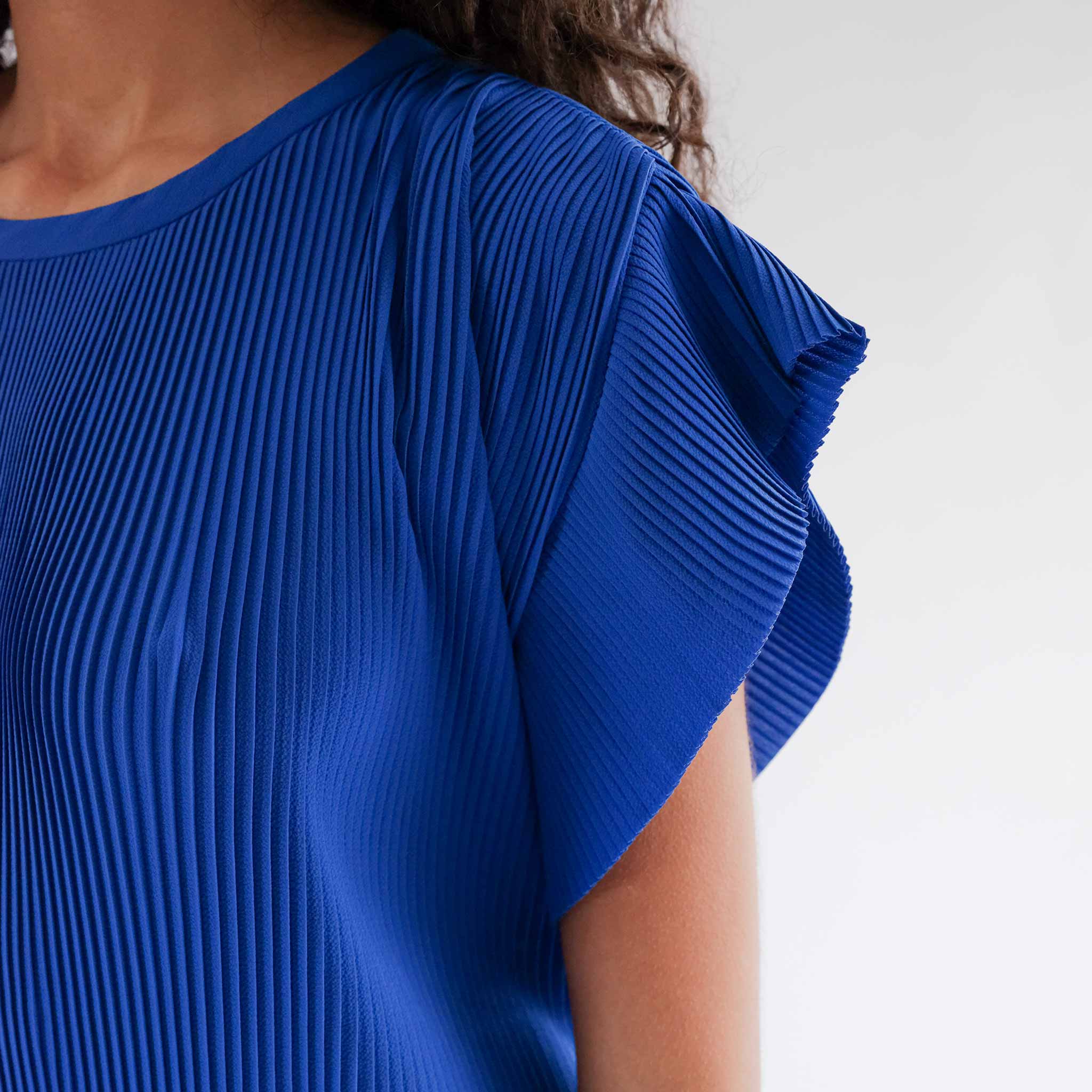 Close detail photo of the Pina Plissé Dress sleeve.
