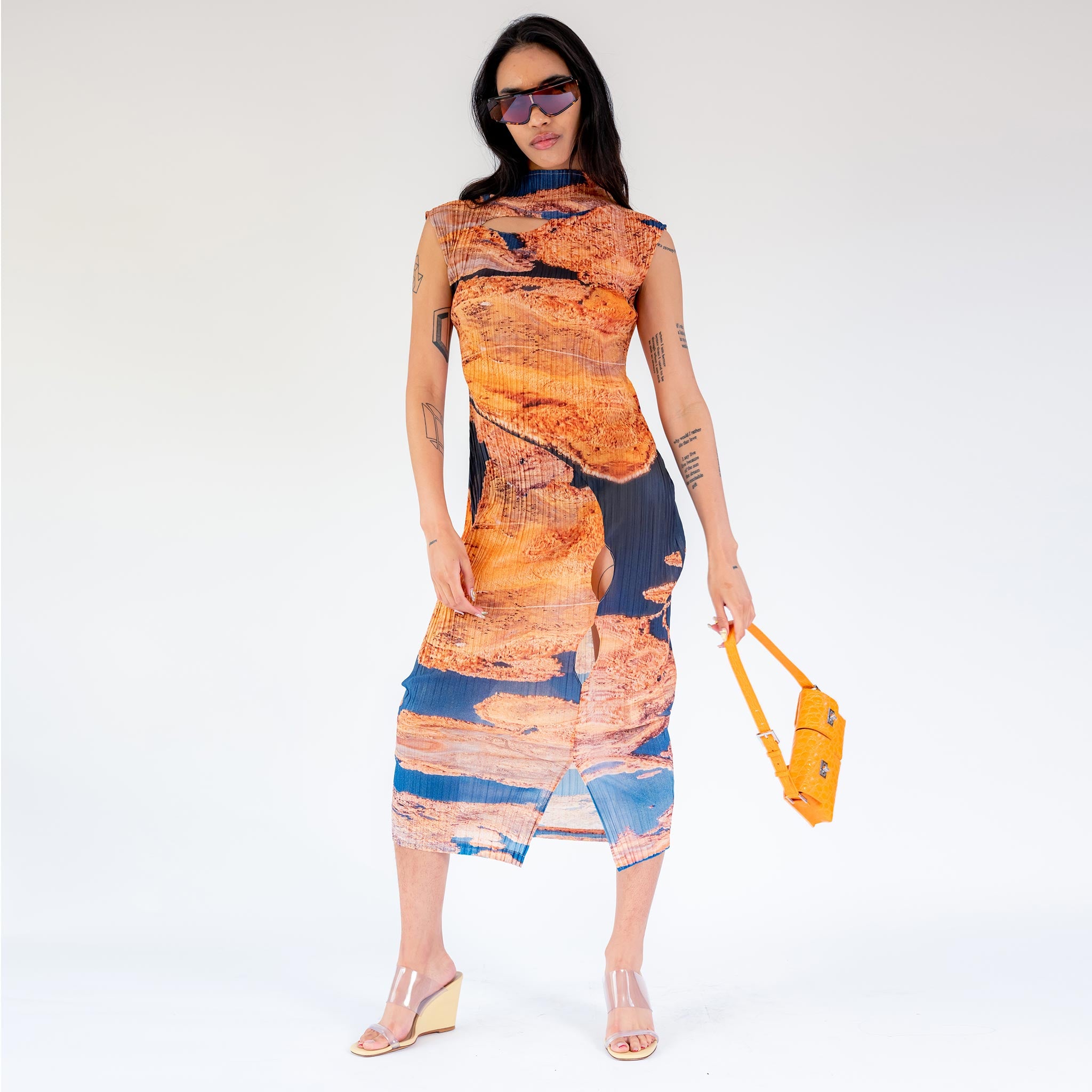 Full body photo of model wearing the Nu Worlds Pleated Dress - Aerial View.