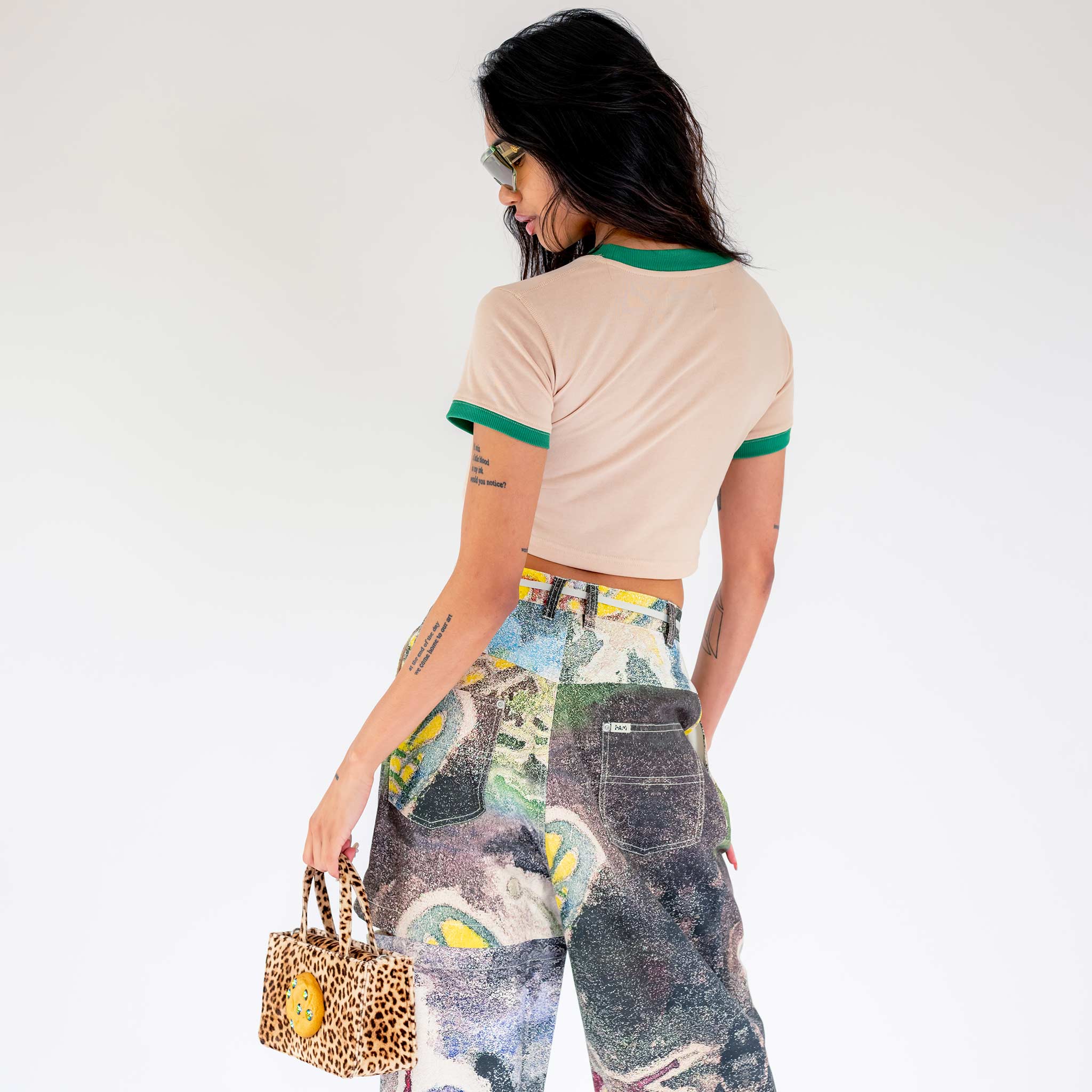 Back half body photo of model wearing the Power Baby Tee - Beige.