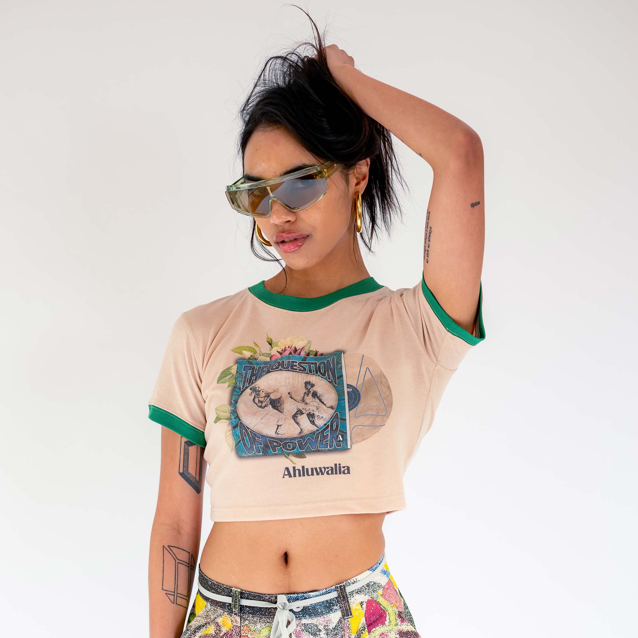 Close half body photo of model wearing the Power Baby Tee - Beige.