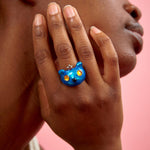 Blue metallic Princess Bear Ring by Collina Strada as worn on the hand.