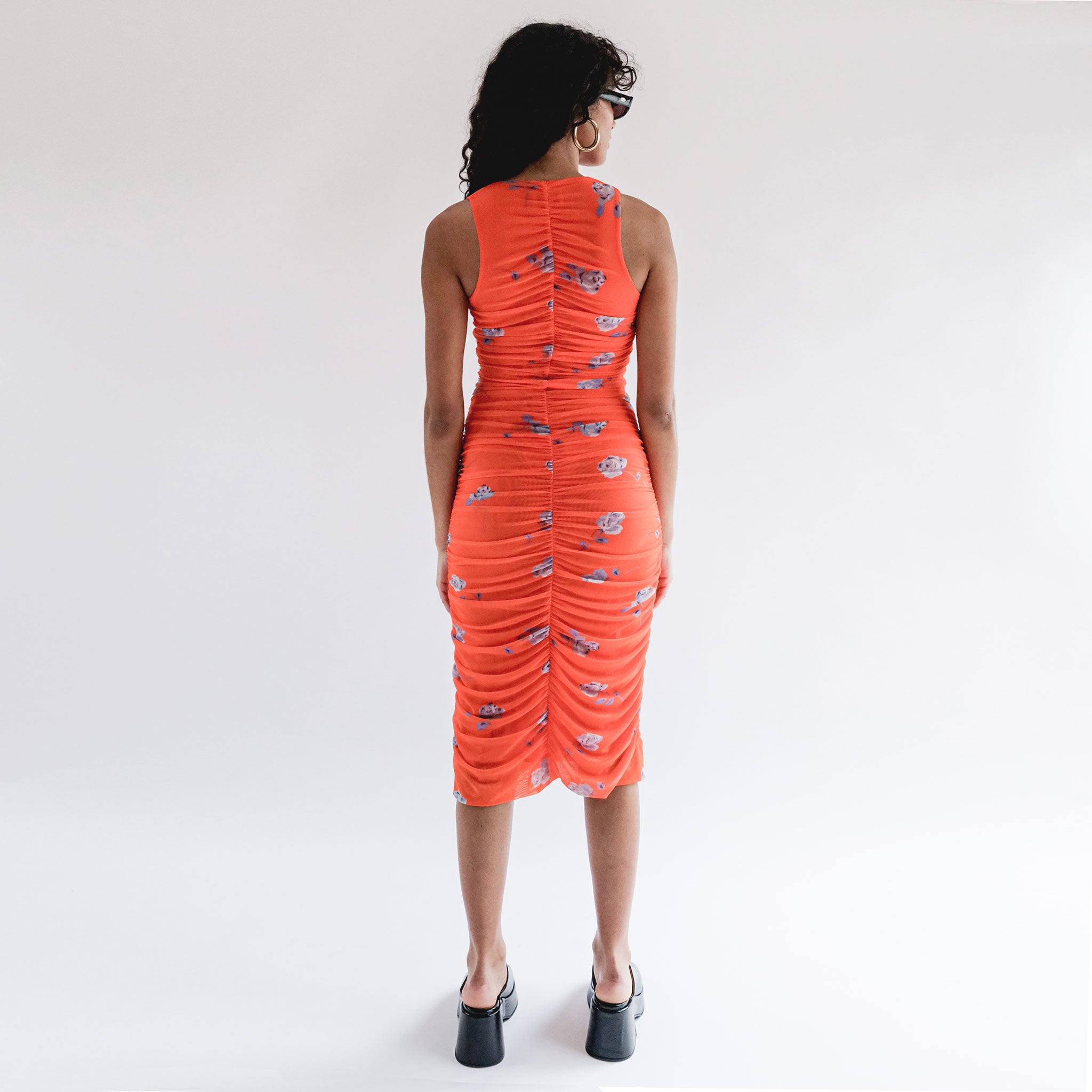 Back full body photo of model wearing the Printed Mesh Ruched Sleeveless Midi Dress - Orangeade.