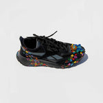 Side view of the collina strada black reebok sneaker with colorful painted flowers and a rhinestone toe clip.