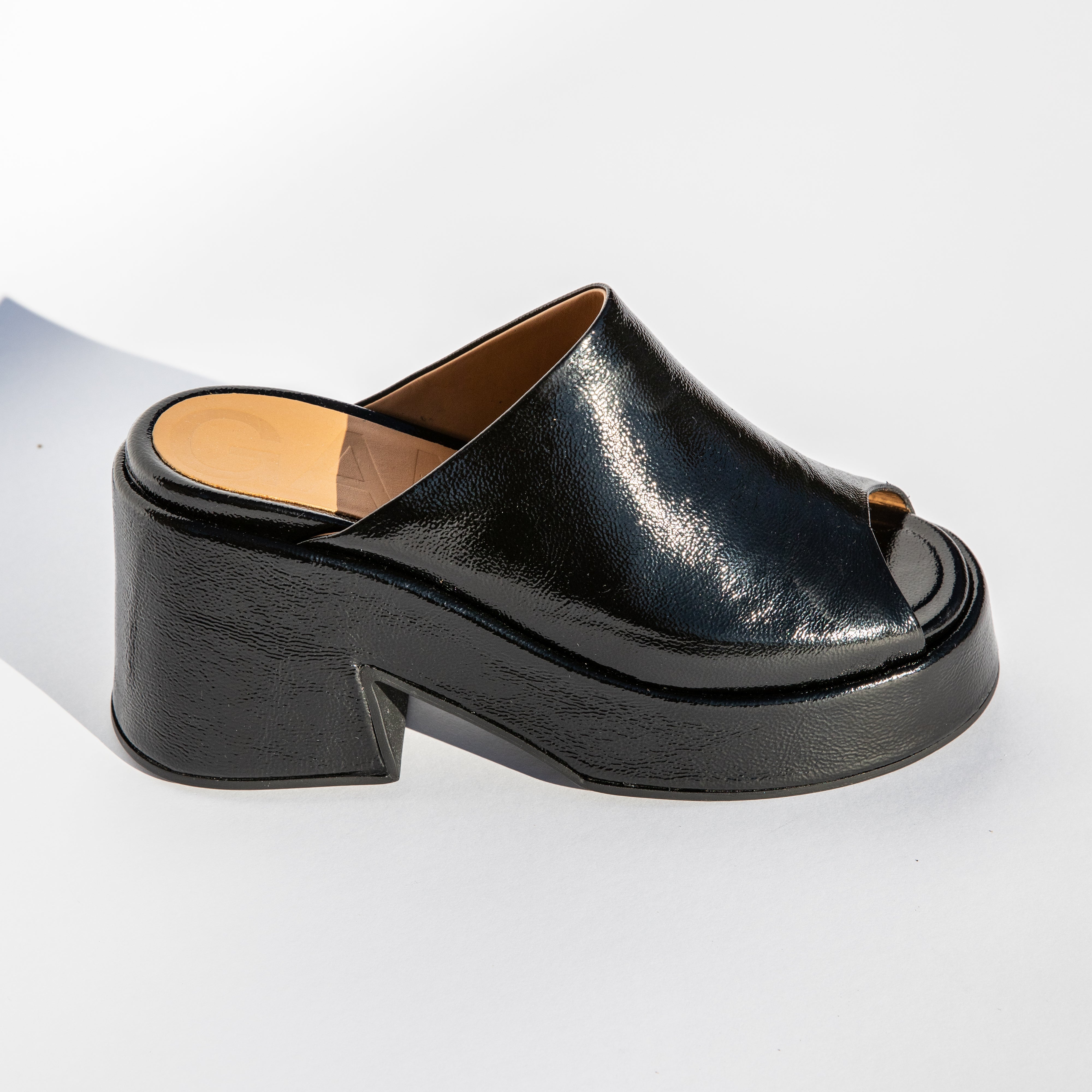 Close detail photo of the Retro Platform Wedge Mule - Black .