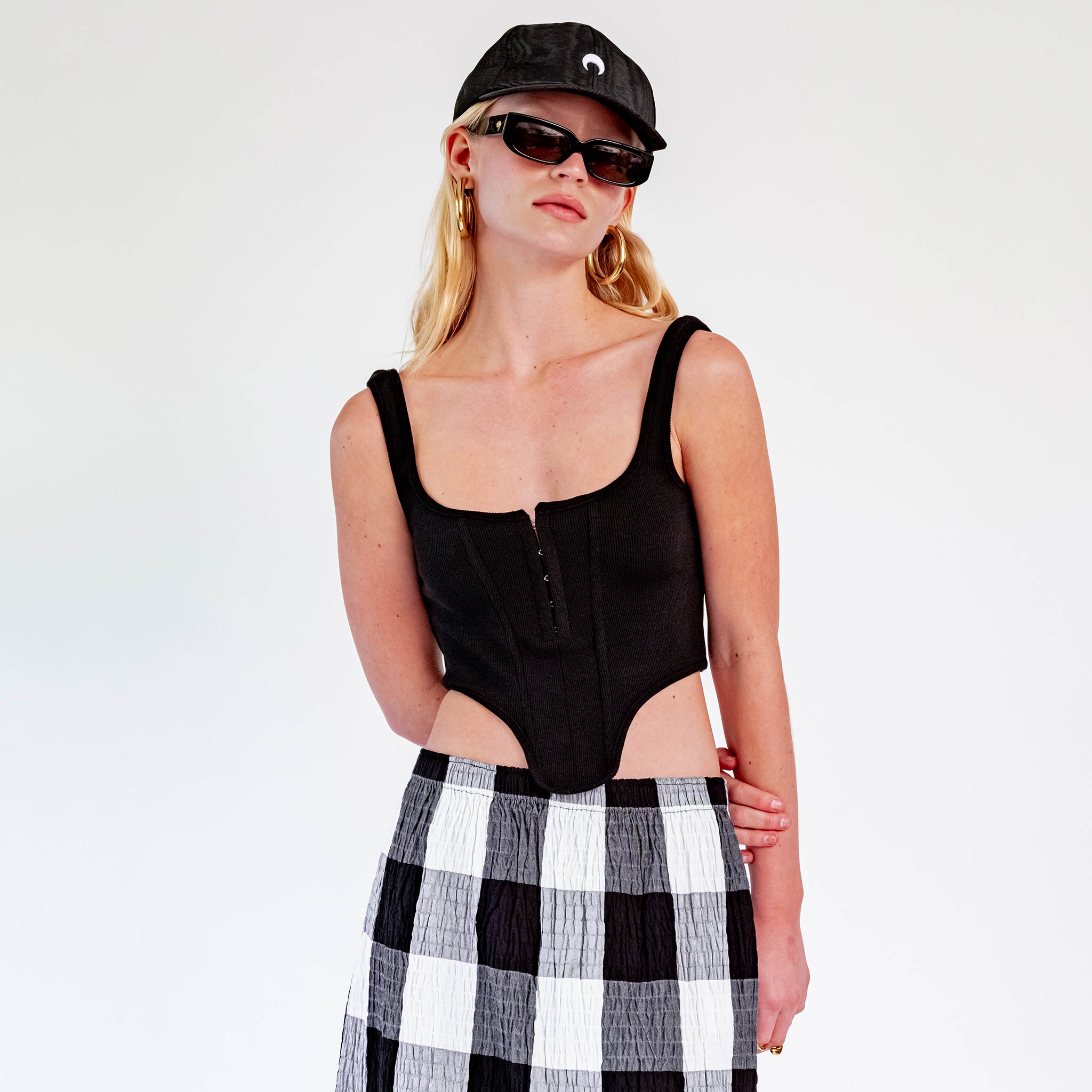 Close half body photo of model wearing the Ribbed Corset Top - Black.