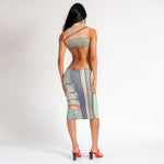 Back view of the sleeveless printed ribbed Ribboned Dress by Eckhaus Latta, which falls below the knee.