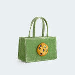 Angled view of the Small Jeweled Cookie bag in green velvet.