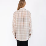 Back half body photo of model wearing the Sheer Foundation Button Down - Greige.