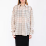Close half body photo of model wearing the Sheer Foundation Button Down - Greige.