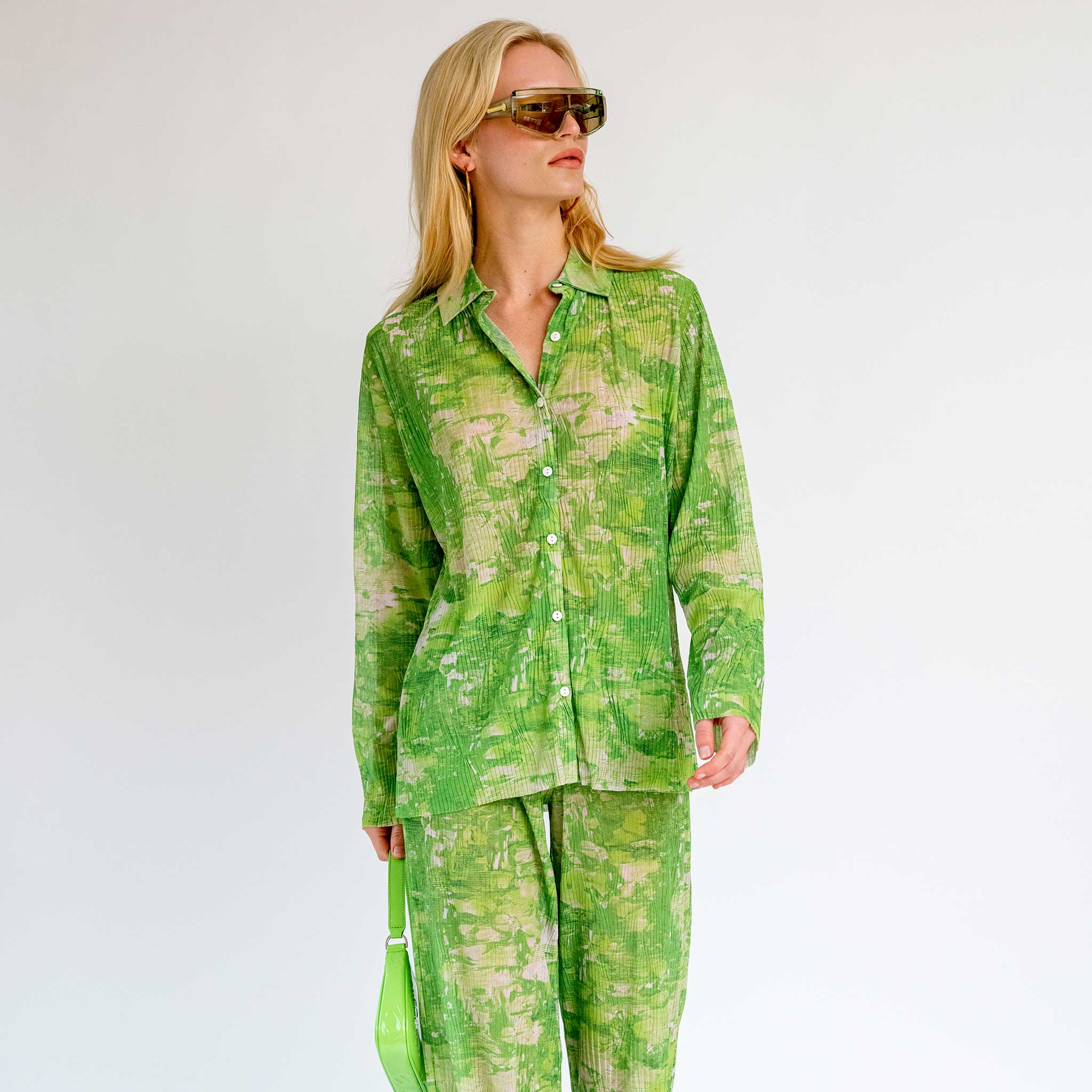 Close half body photo of model wearing the Short Mesh Plisse Shirt - Green Riddle.