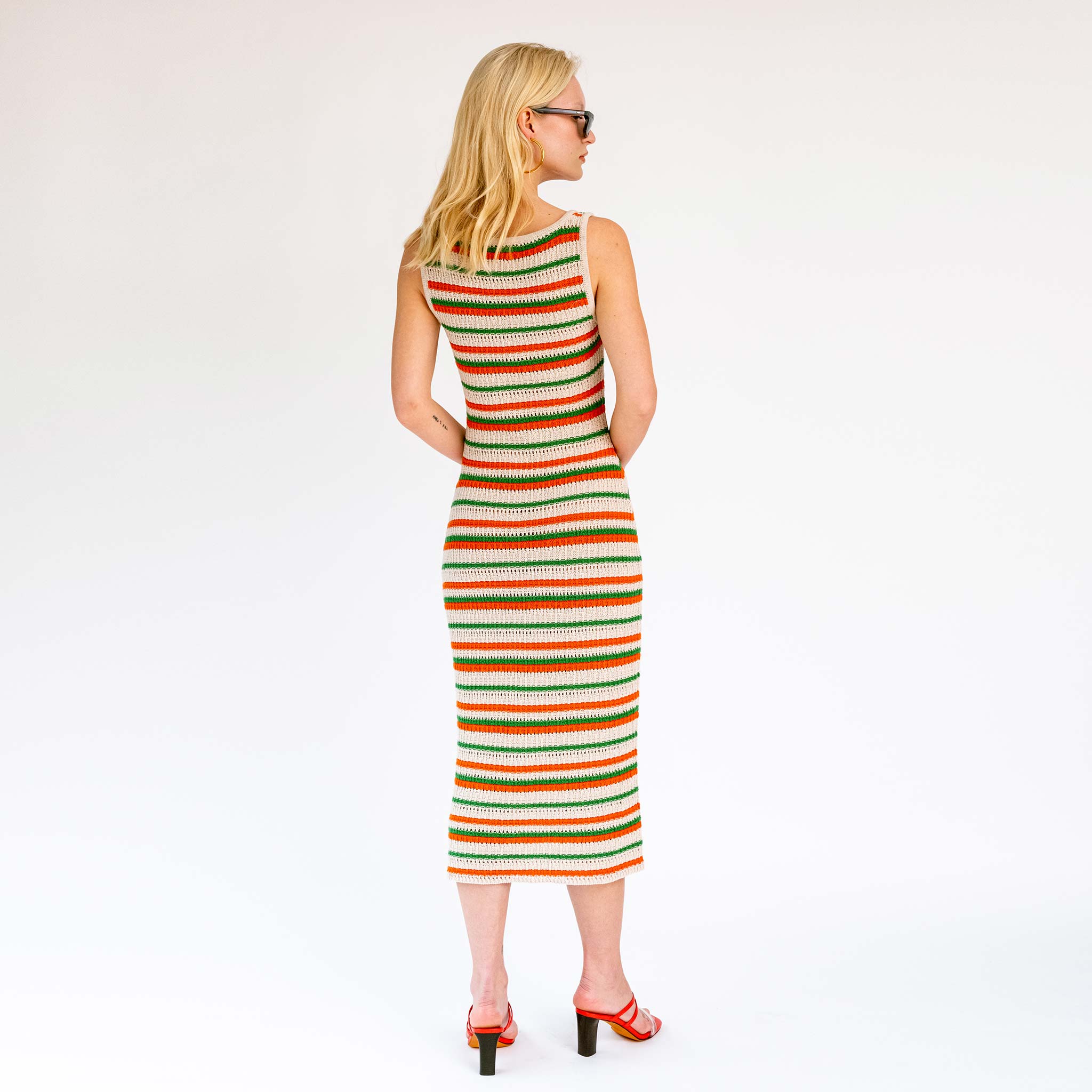 Back full body photo of model wearing the Striped Knit Midi Dress - Green Orange.