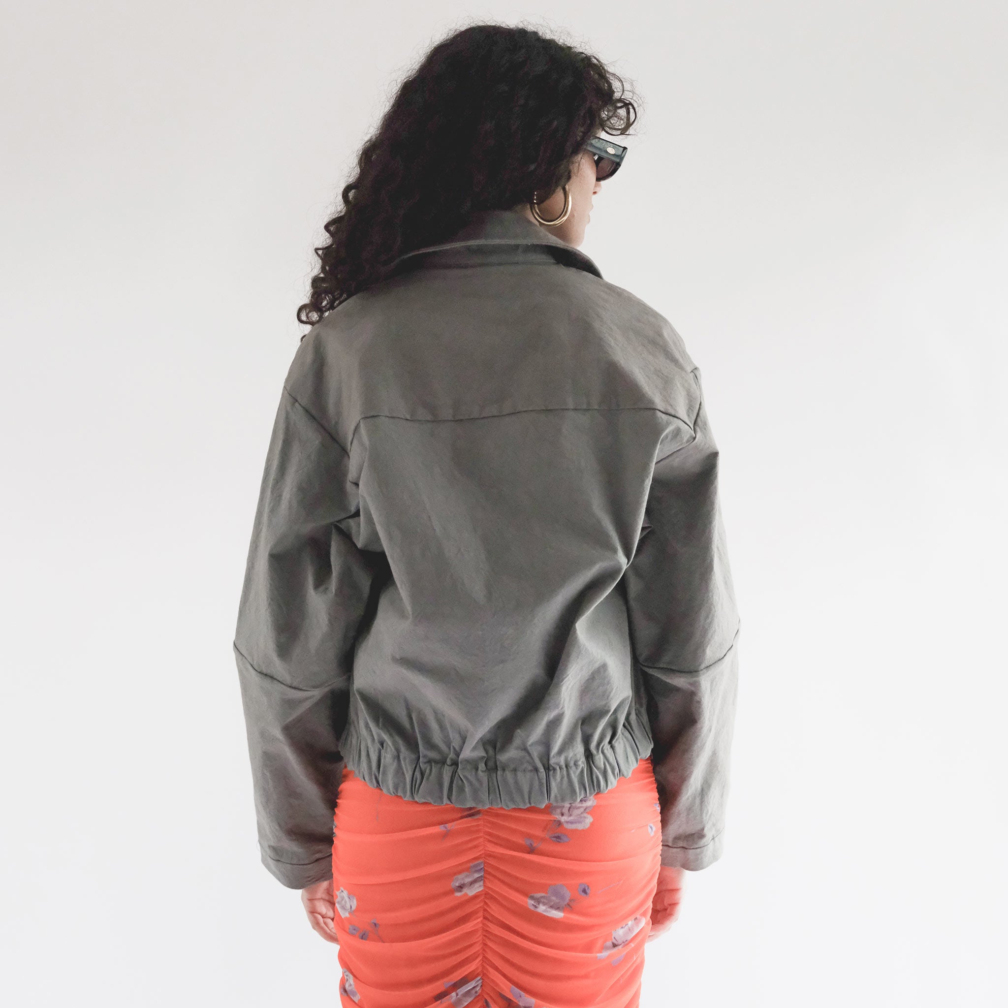 Back half body photo of model wearing the Structure Jacket - Steel.