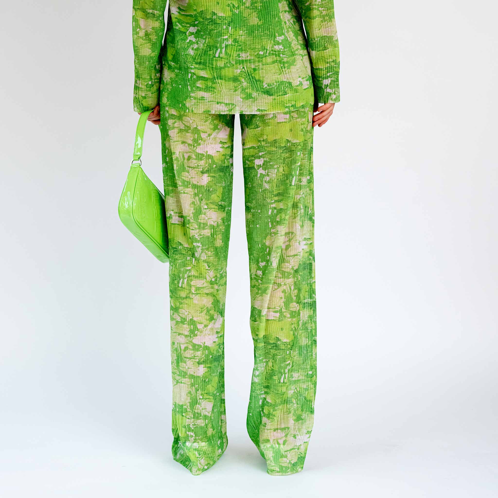Back half body photo of model wearing the Sway Mesh Plisse Pants - Green Riddle.