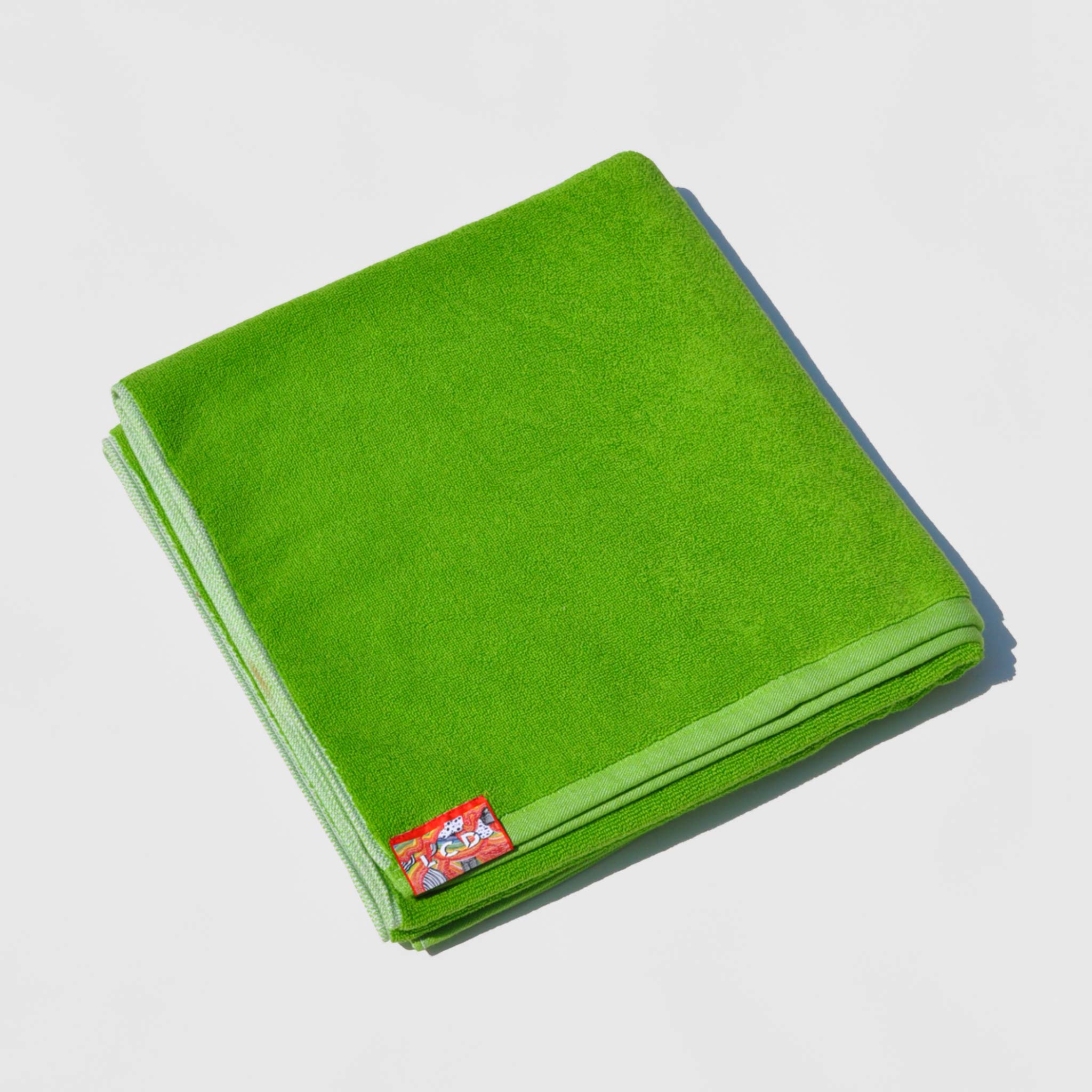 Flat image of the jacquard beach & bath towel in light lime by LCD.