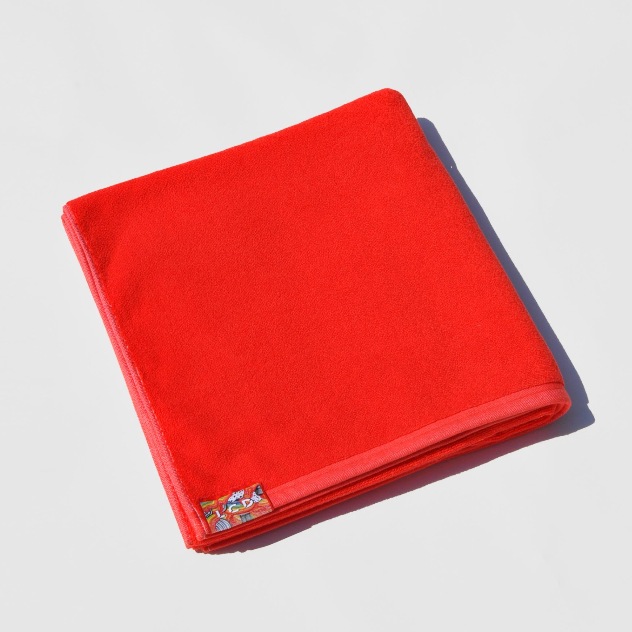 Flat image of the jacquard beach & bath towel in light red by LCD.