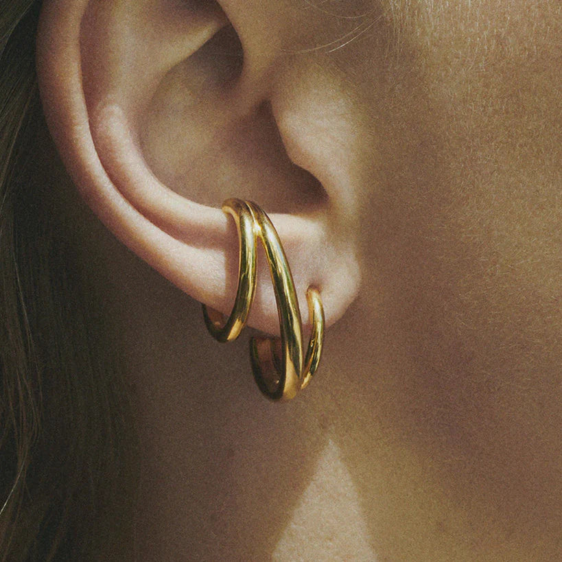 Close detail photo of model wearing the Triplet Earring - Gold Vermeil .
