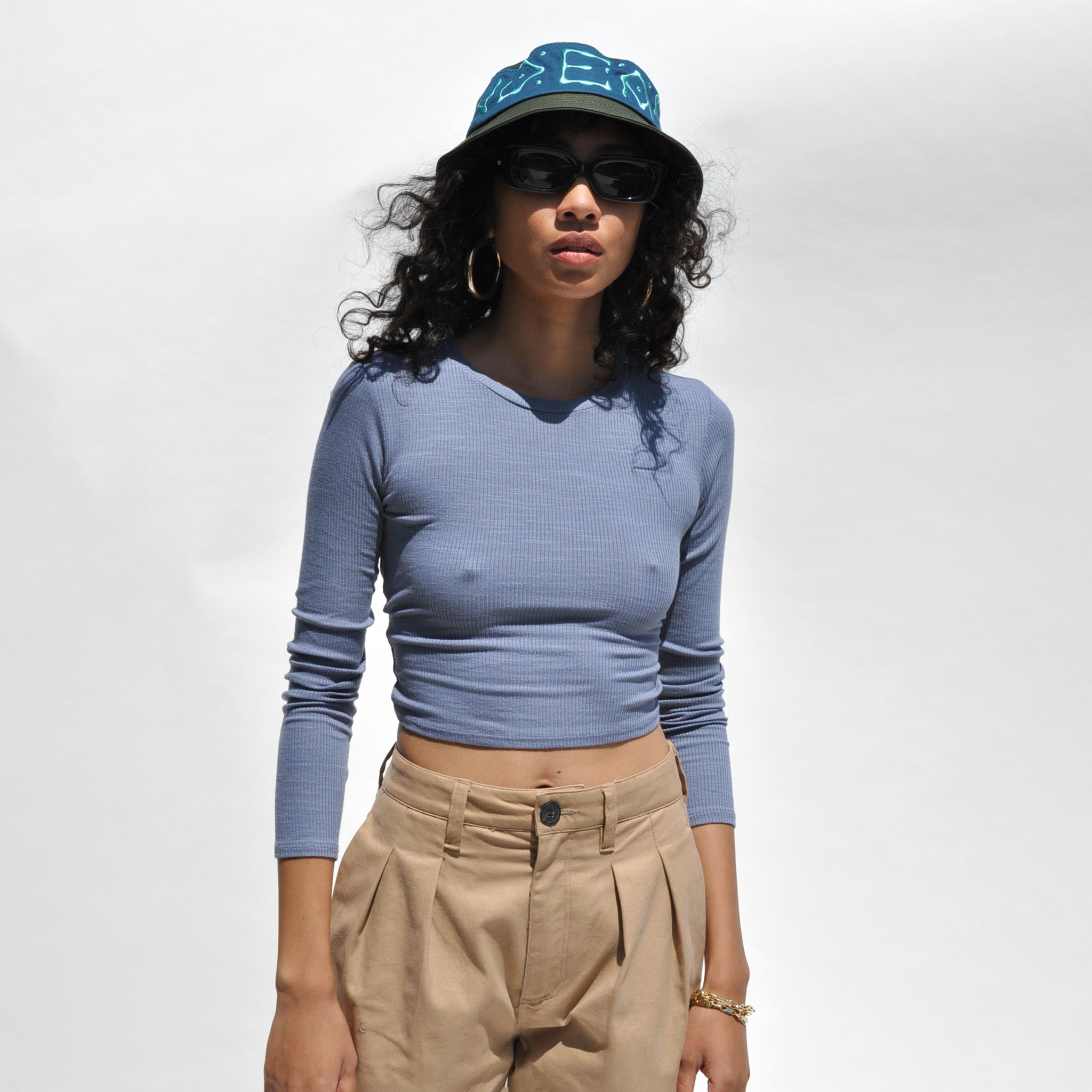 Close detail photo of model wearing the Twist Back Cropped Top in Slate Blue