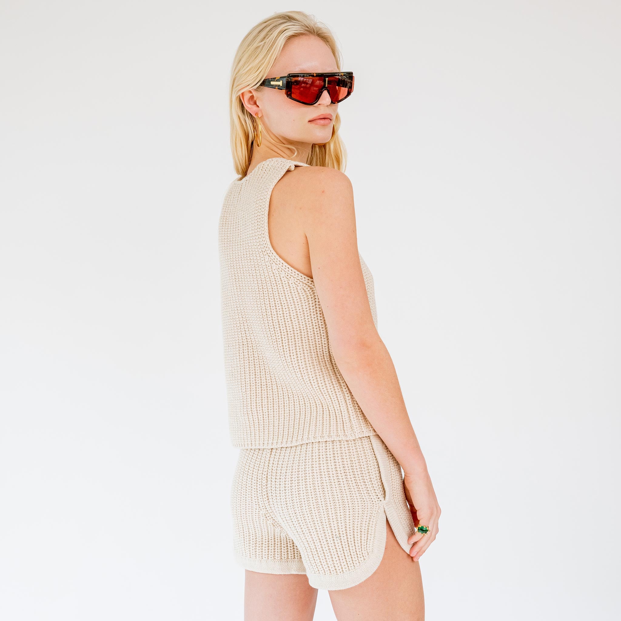 Back half body photo of model wearing the V-Neck Knit Top - Oat.