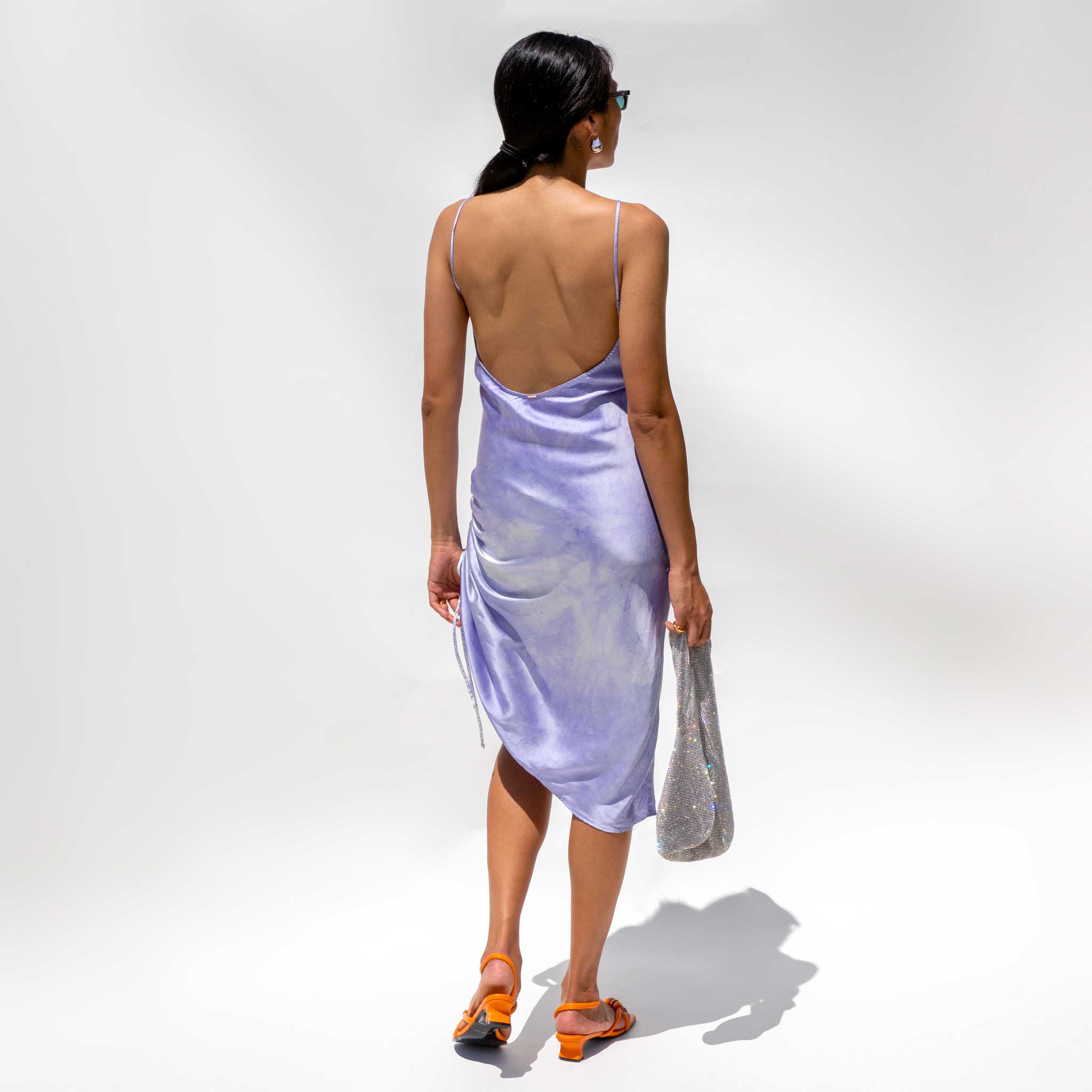 Back detail photo of model wearing the SVNR Vee Midi Slip Dress in Twilight.