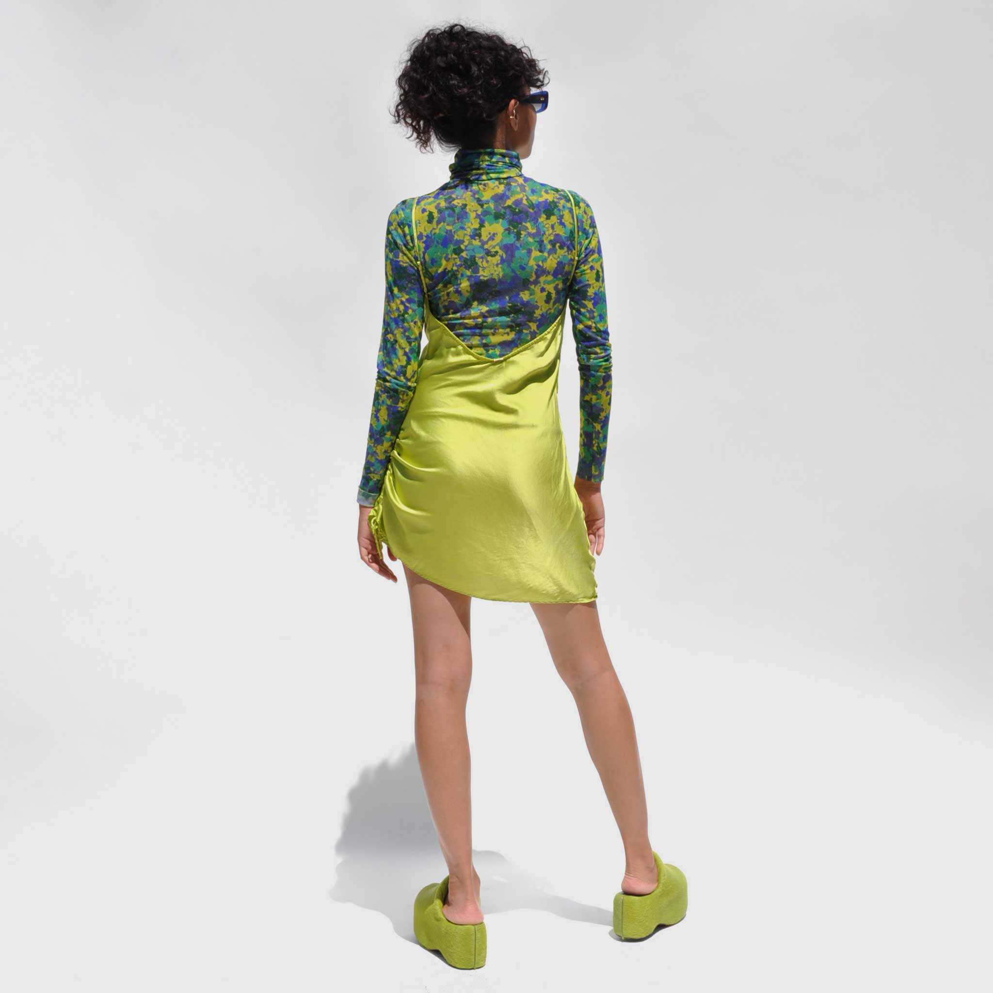 Back detail photo of model wearing the Vee Mini Slip Dress - Grass