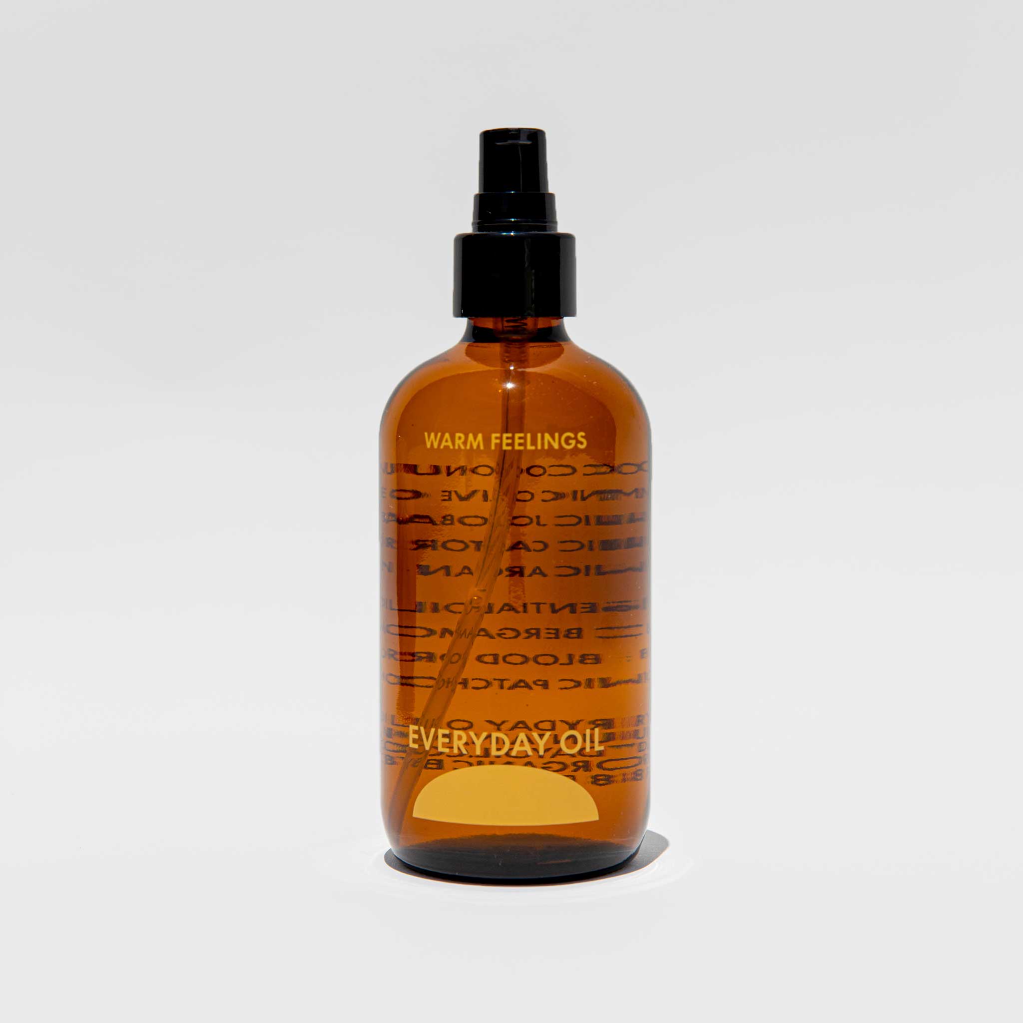 Close detial photo of the 8oz everyday oil warm feelings bottle.