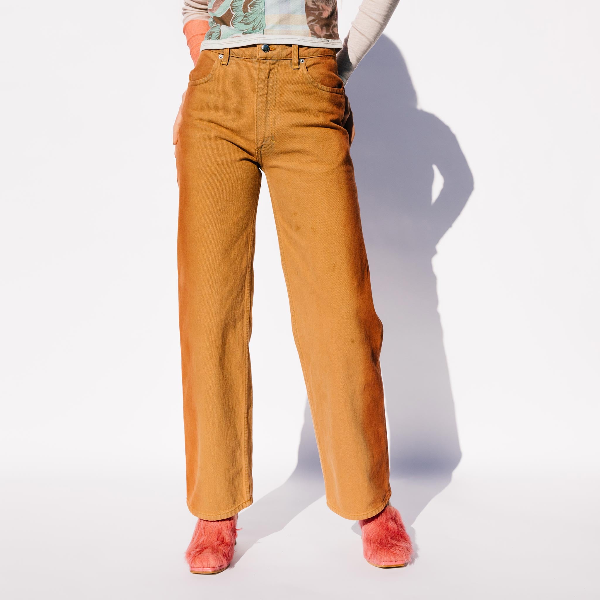 Close detail photo of model wearing the Wide Leg Jean - Terracota.