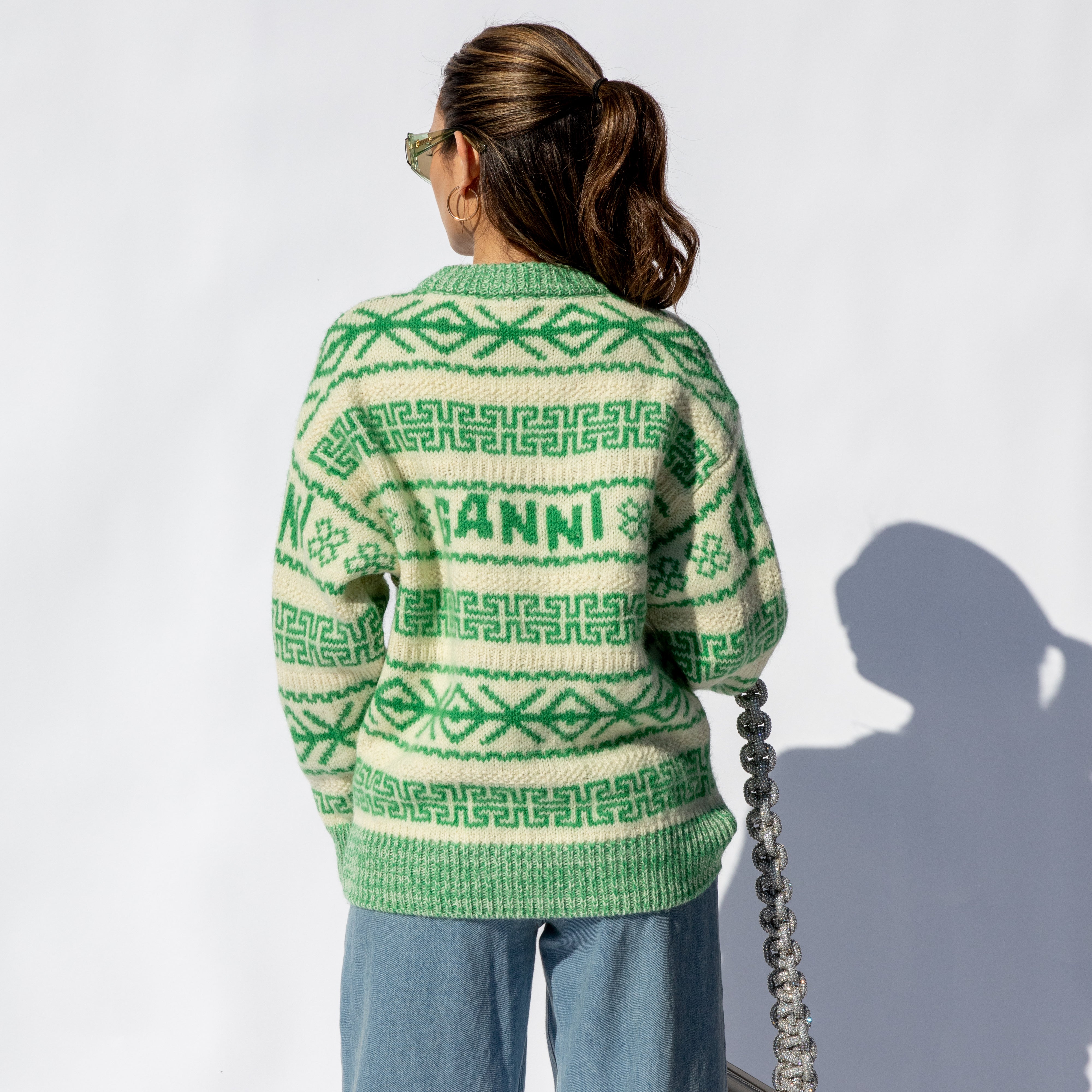 Back half body photo of model wearing the Winter Pullover - Egret.
