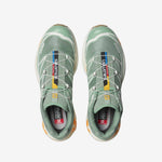 Salomon XT-6 sneakers in a pale green colorway with light orange trim along the sole. Top view.