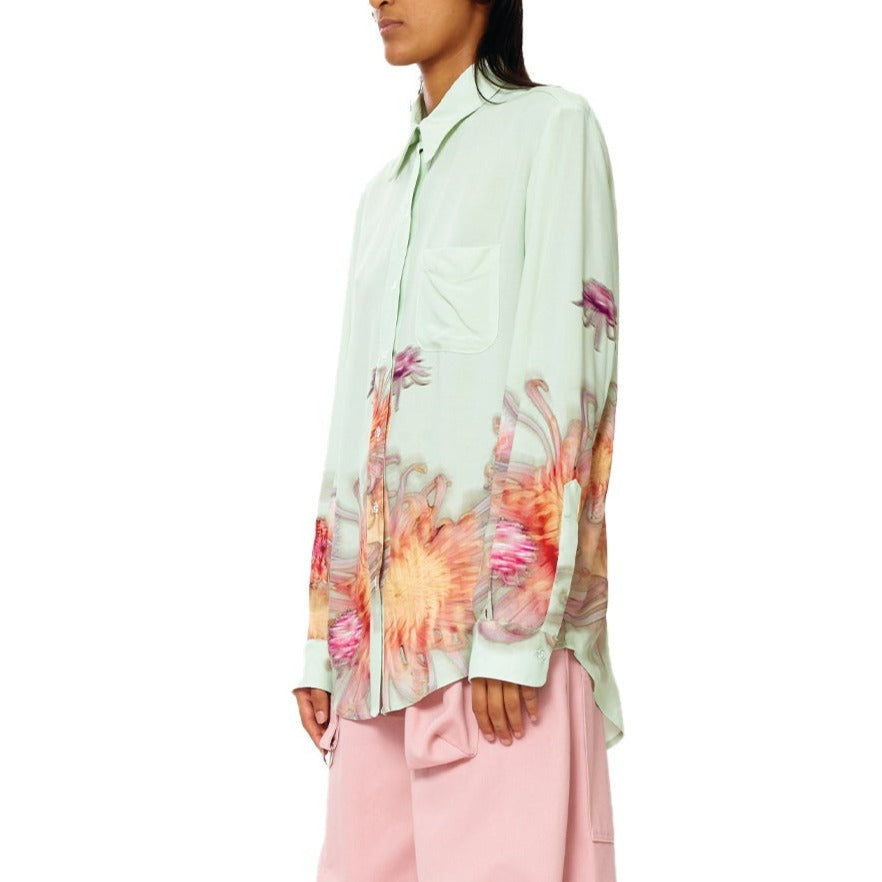 Close half body photo of model wearing the Convention Button Up - Mint Chrysanthemum.